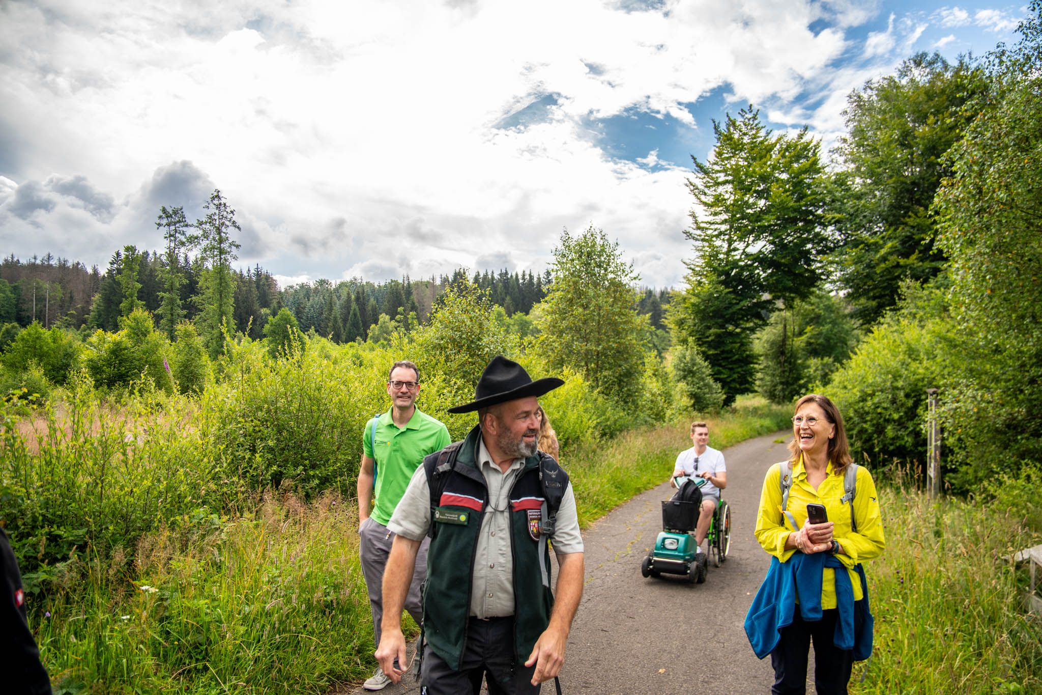 Ranger in the national park with hiker and Swiss Track