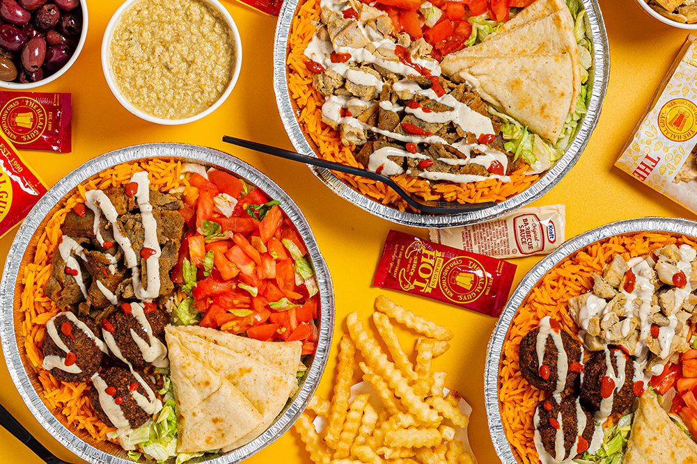 Three Halal guys platters of food