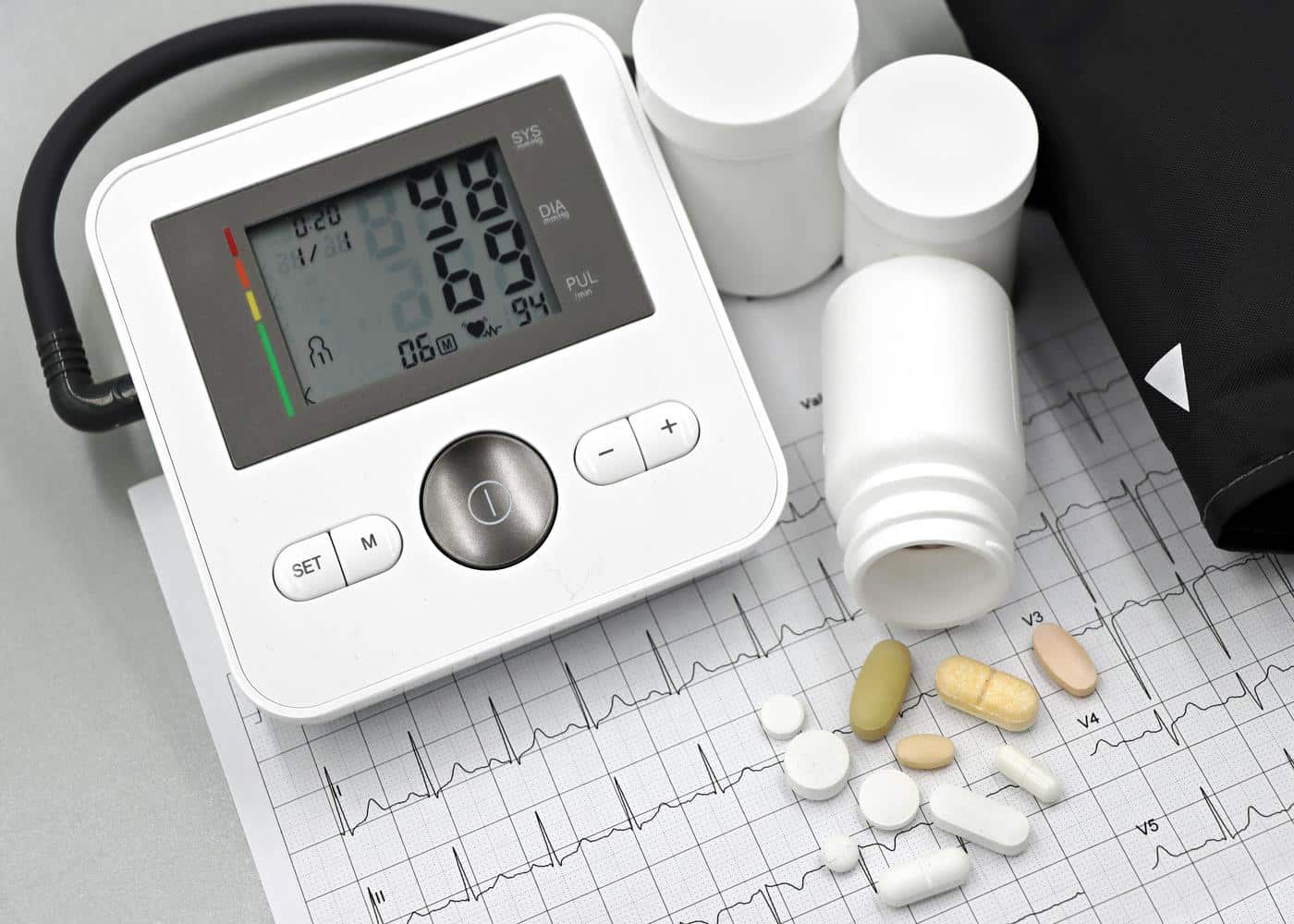 Portable eeg monitor, spilled tablets and a heartrate graph on a desk