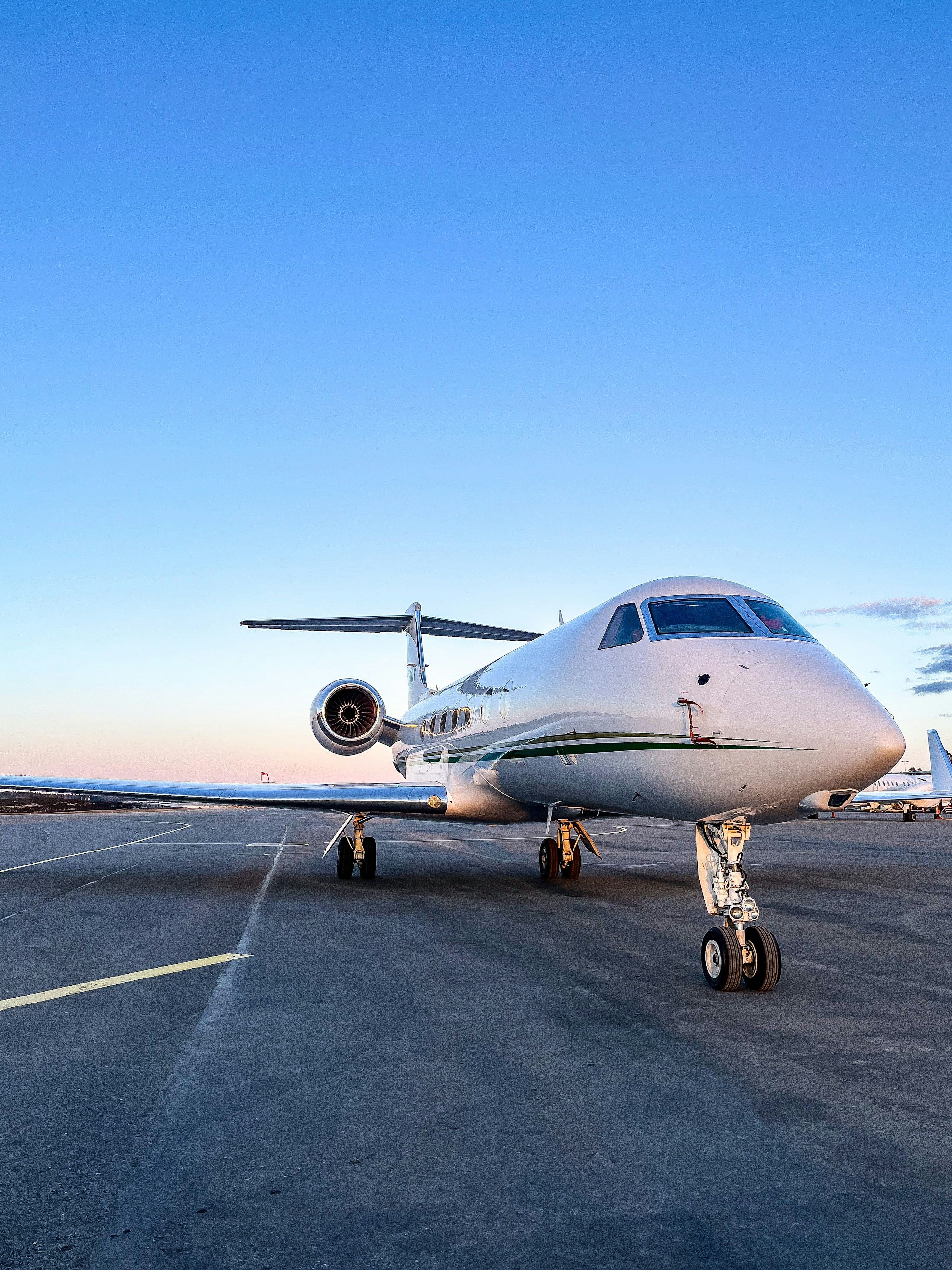 a small white jet sitting on top of an airport tarmac