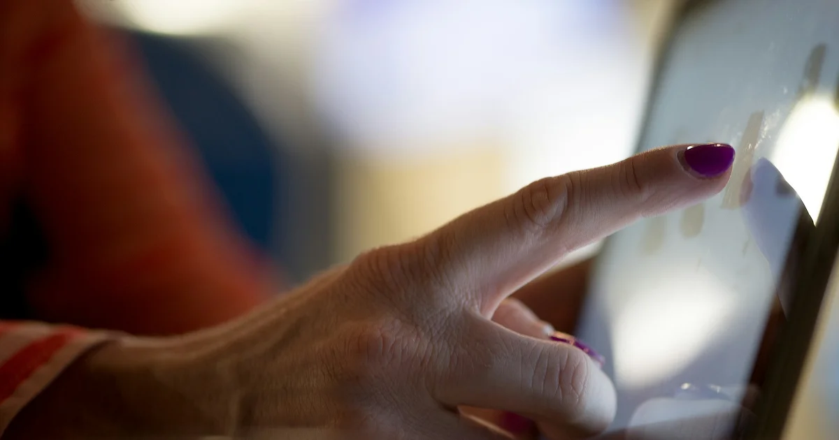 Person using a digital touchscreen interface, representing enterprise technology, data governance, and digital sovereignty.
