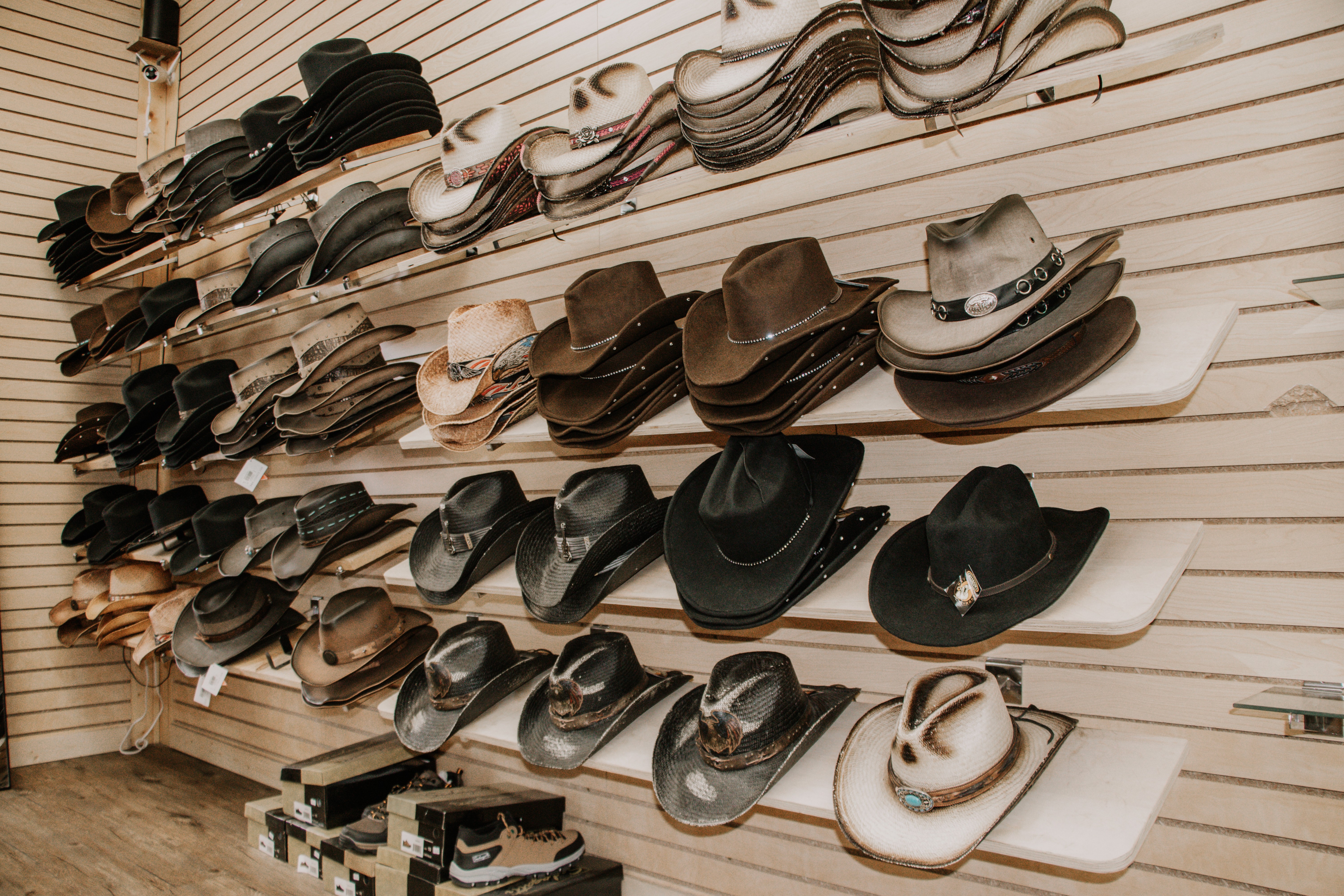 a hand of a man pouring red wine into a glass