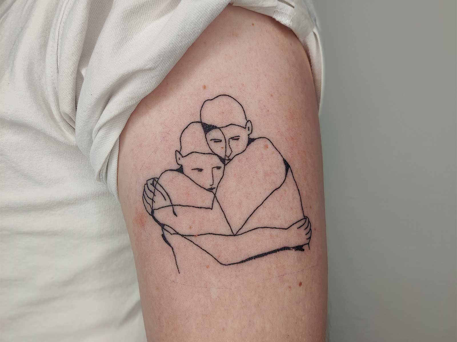 two people hugging tattoo