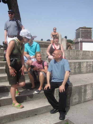 A photo of a group of people visiting old buildings in Rome.