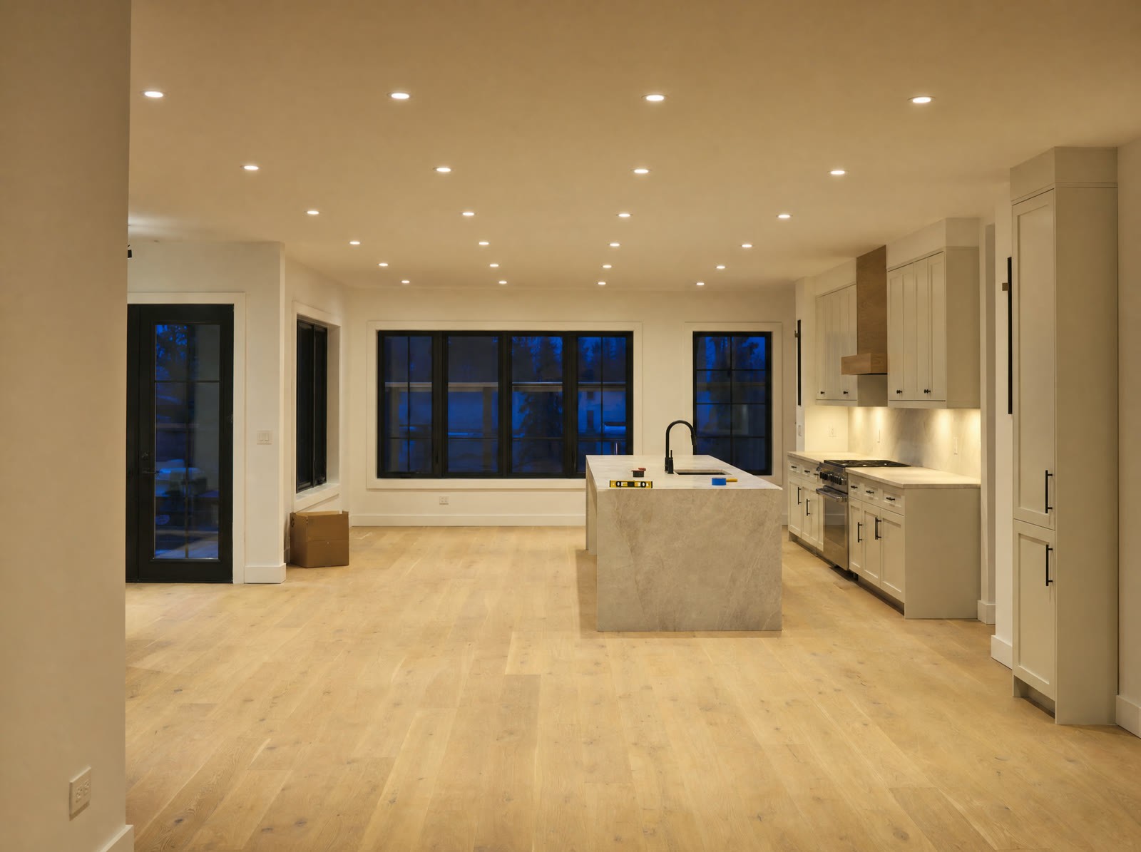 A new-build great room lit by recessed downlights (illustration)