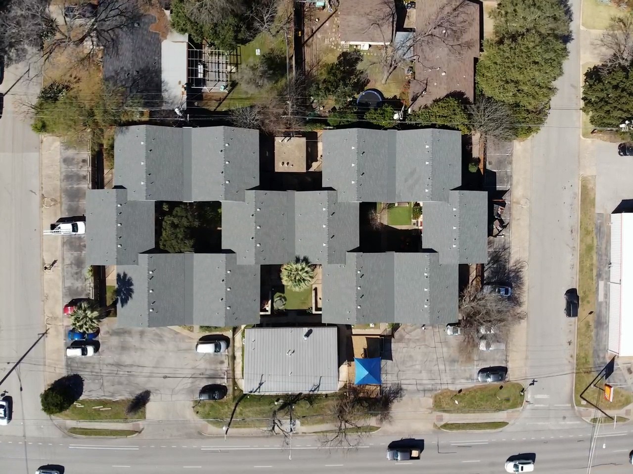 Massive apartment complex in Austin featuring GAF Slate shingles on a gable roof with expertly crafted dead valleys and seamless gutters for optimal drainage and durability.