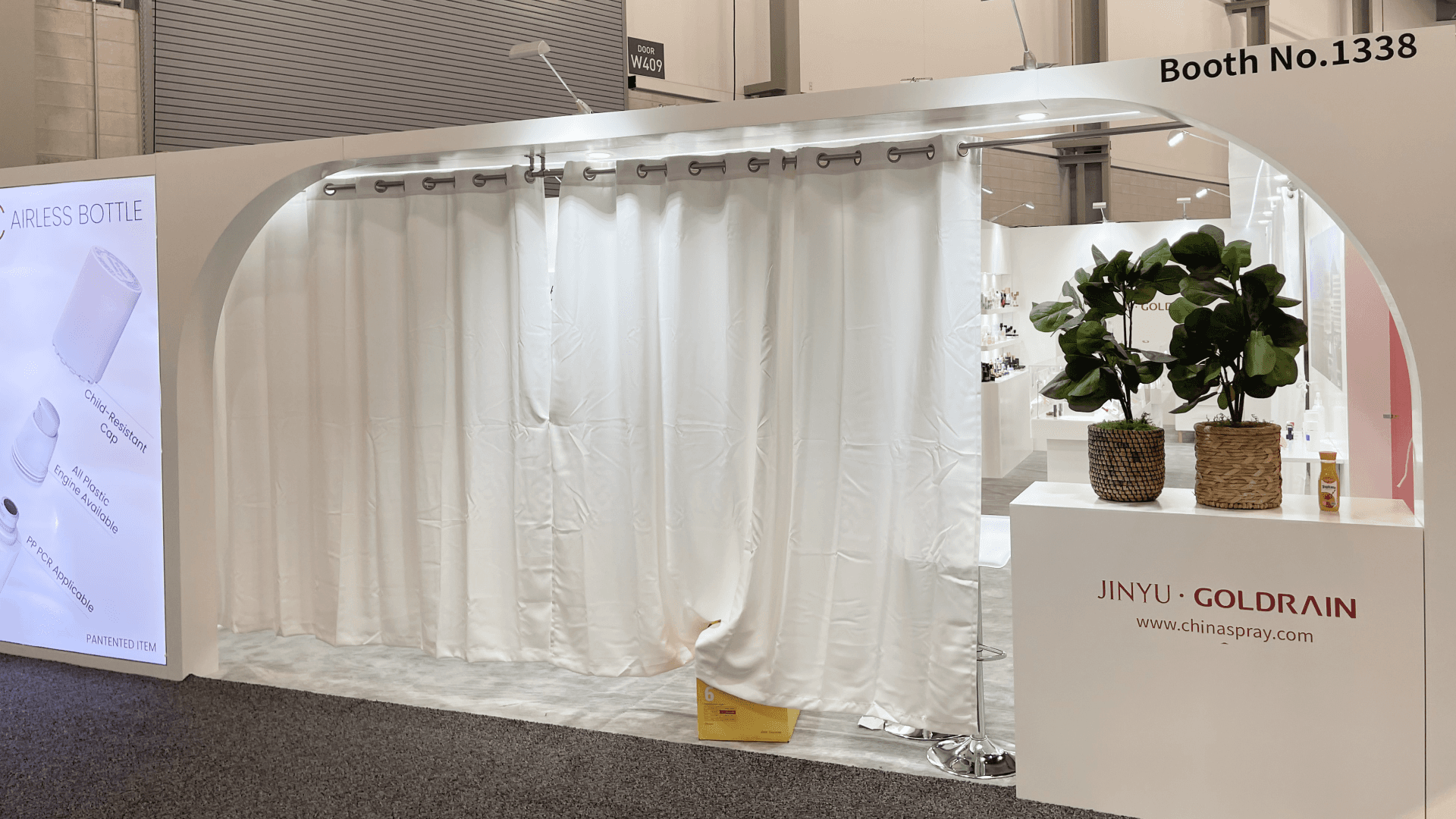 Private meeting lounge area behind curtain screening inside Goldrain 20x30 booth at Cosmoprof 2023
