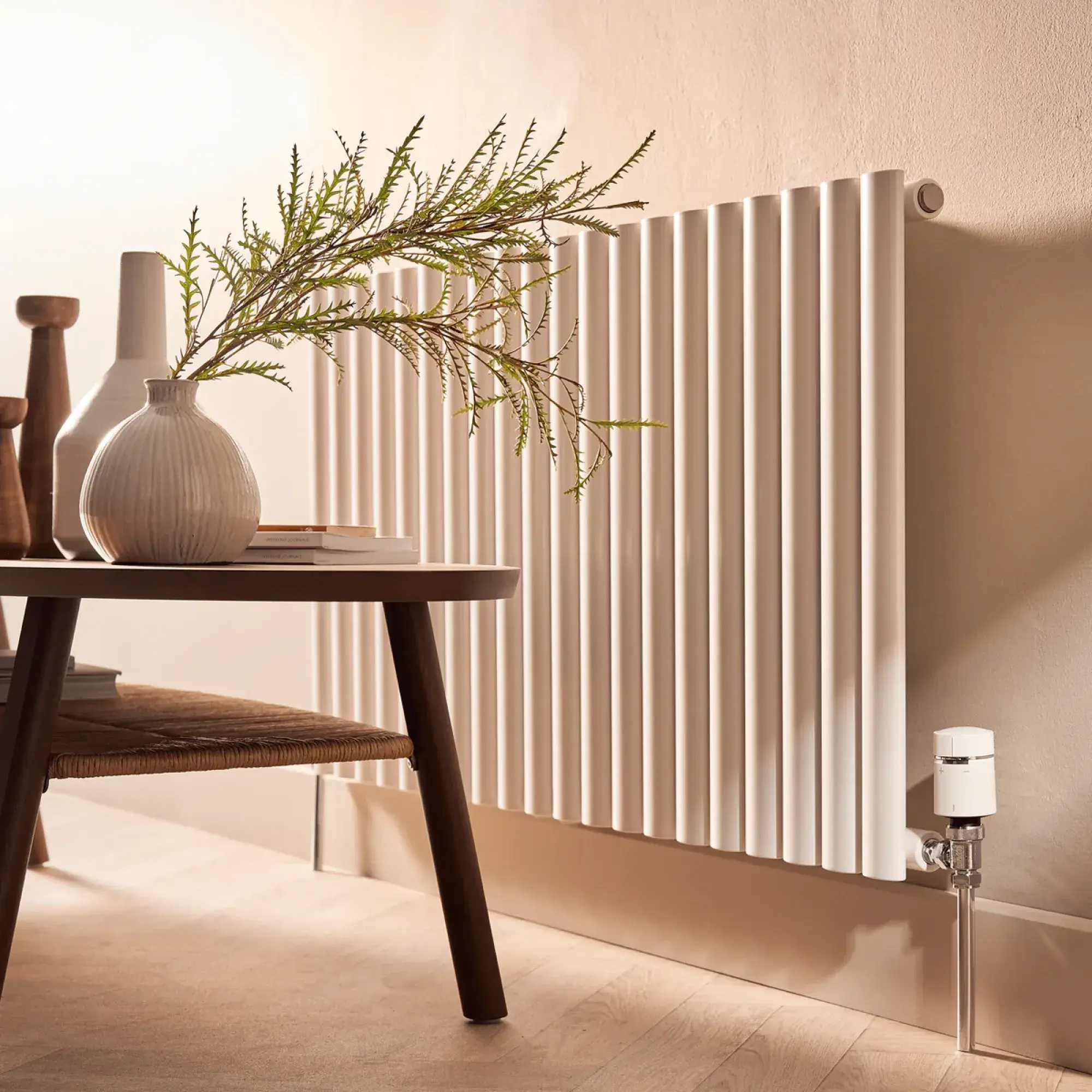 a large metal pot sitting on top of a pile of rocks