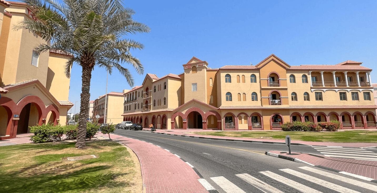 Exterior view of the apartment building situated in International City, featuring contemporary design elements.