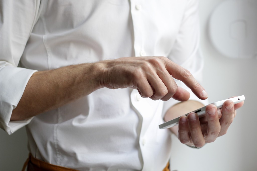 A photo of a person with a hand held device