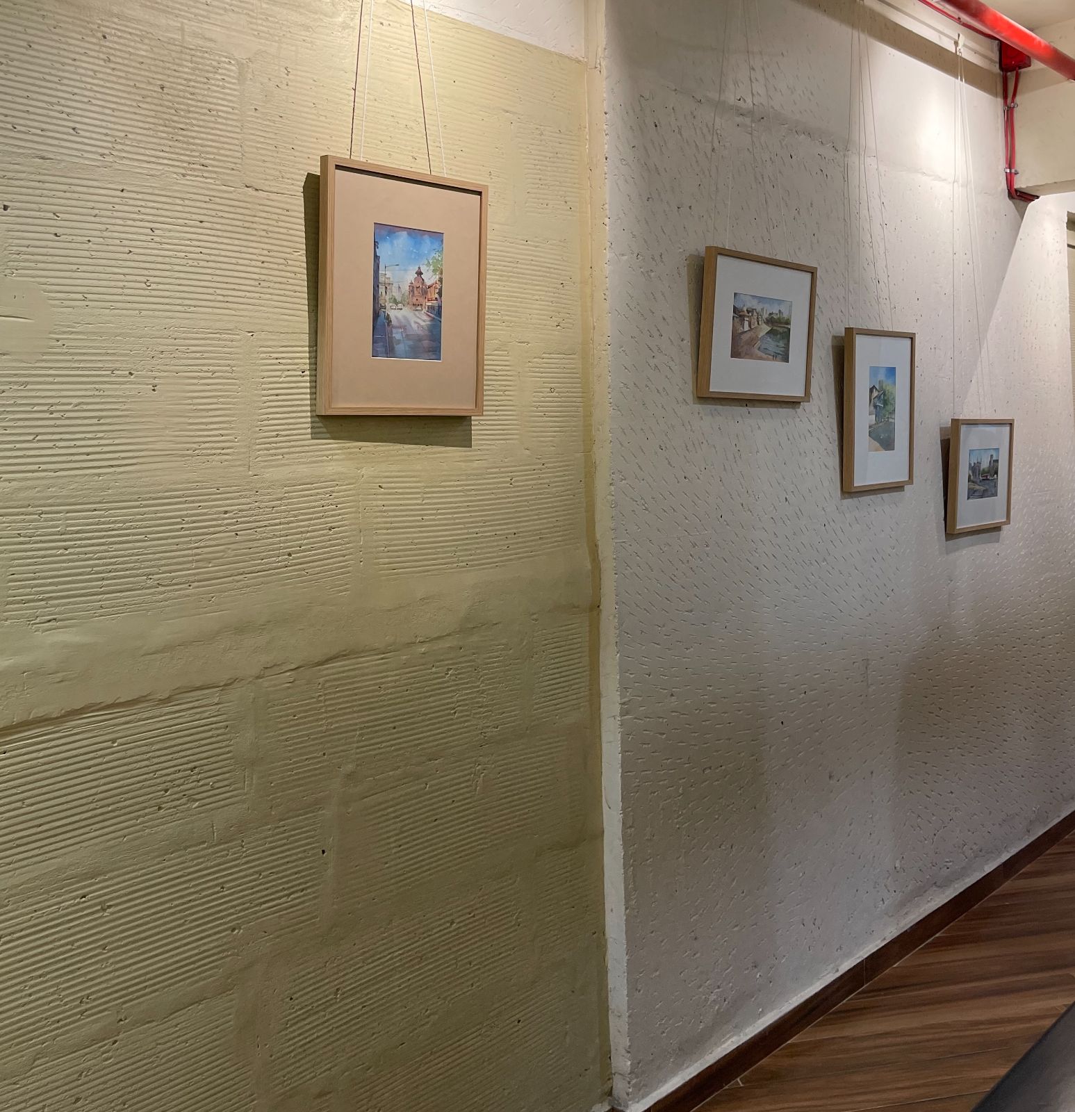 Nature-inspired preschool entrance with sculptural tree partitions and suspended green leaf ceiling panels.