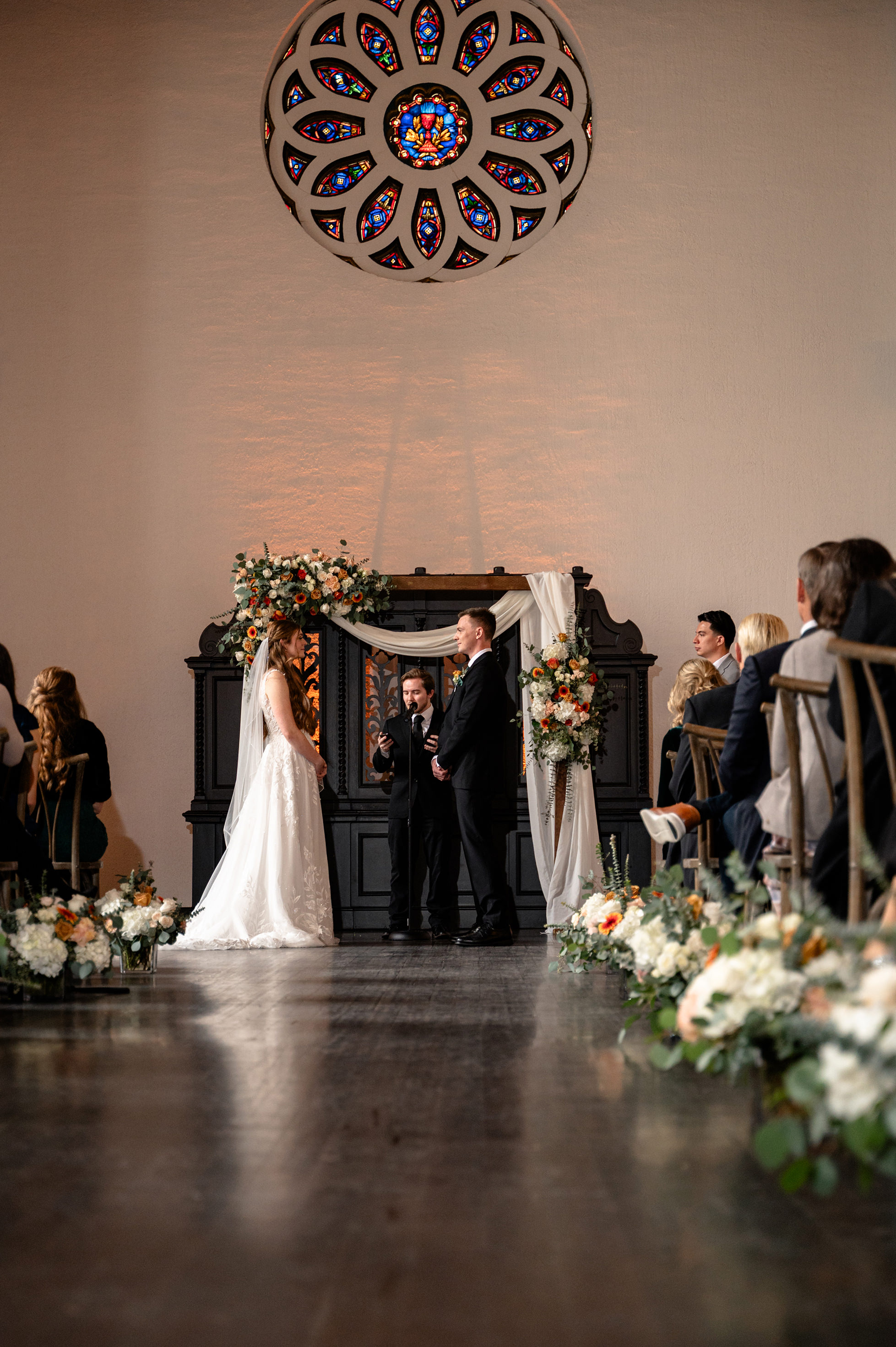 Flat lay wedding details with bouquet, rings, and sparkling bridal heels