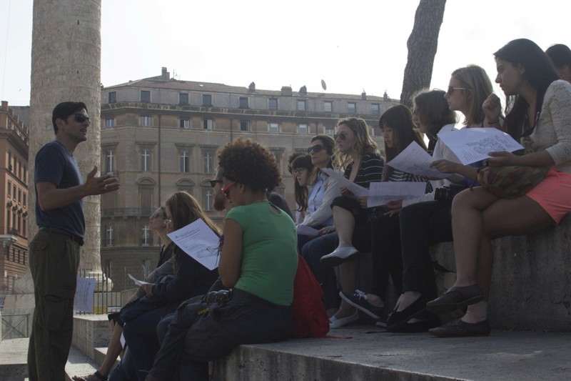 students holding papers looking front