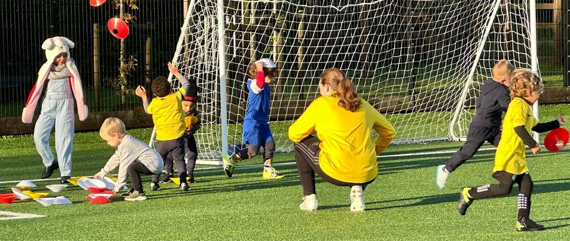 Kids being coached at football