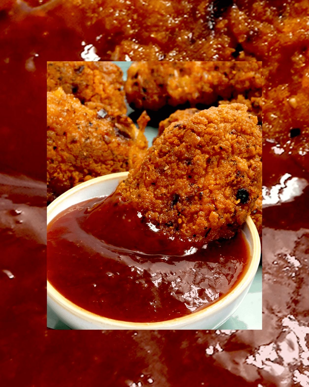 Chicken wings being dipped in sauce