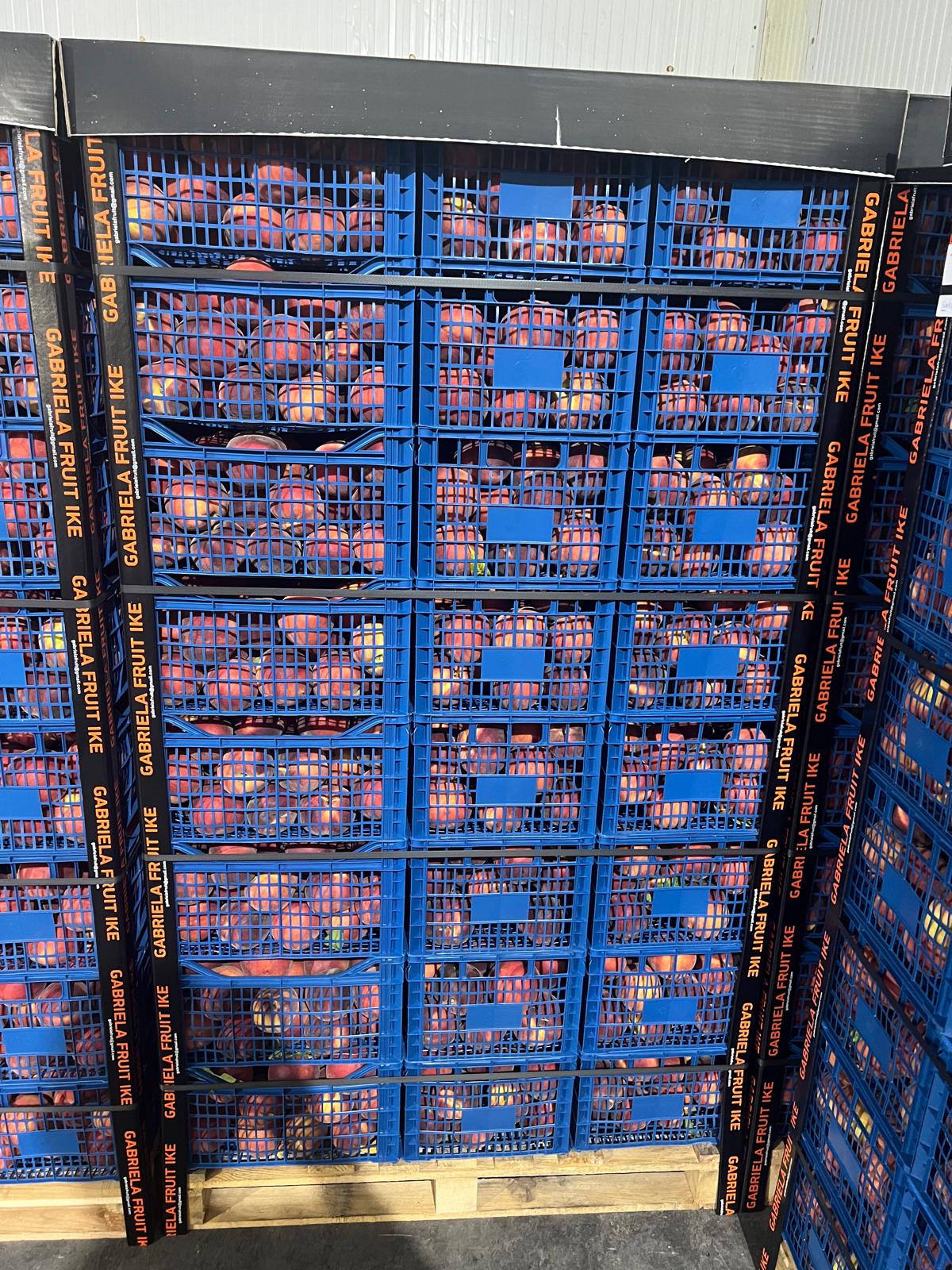 Stacks of fresh peach crates within the cold chain.