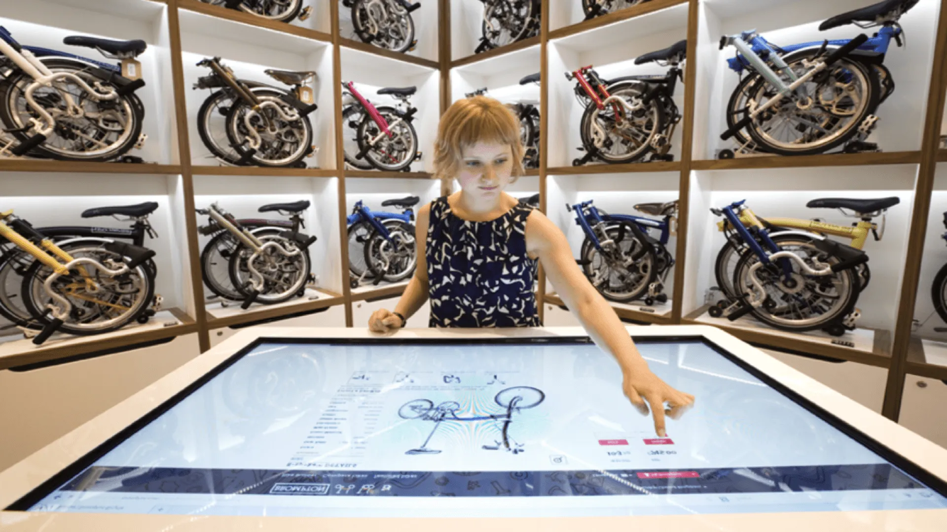 Someone using an in-store bike builder kiosk