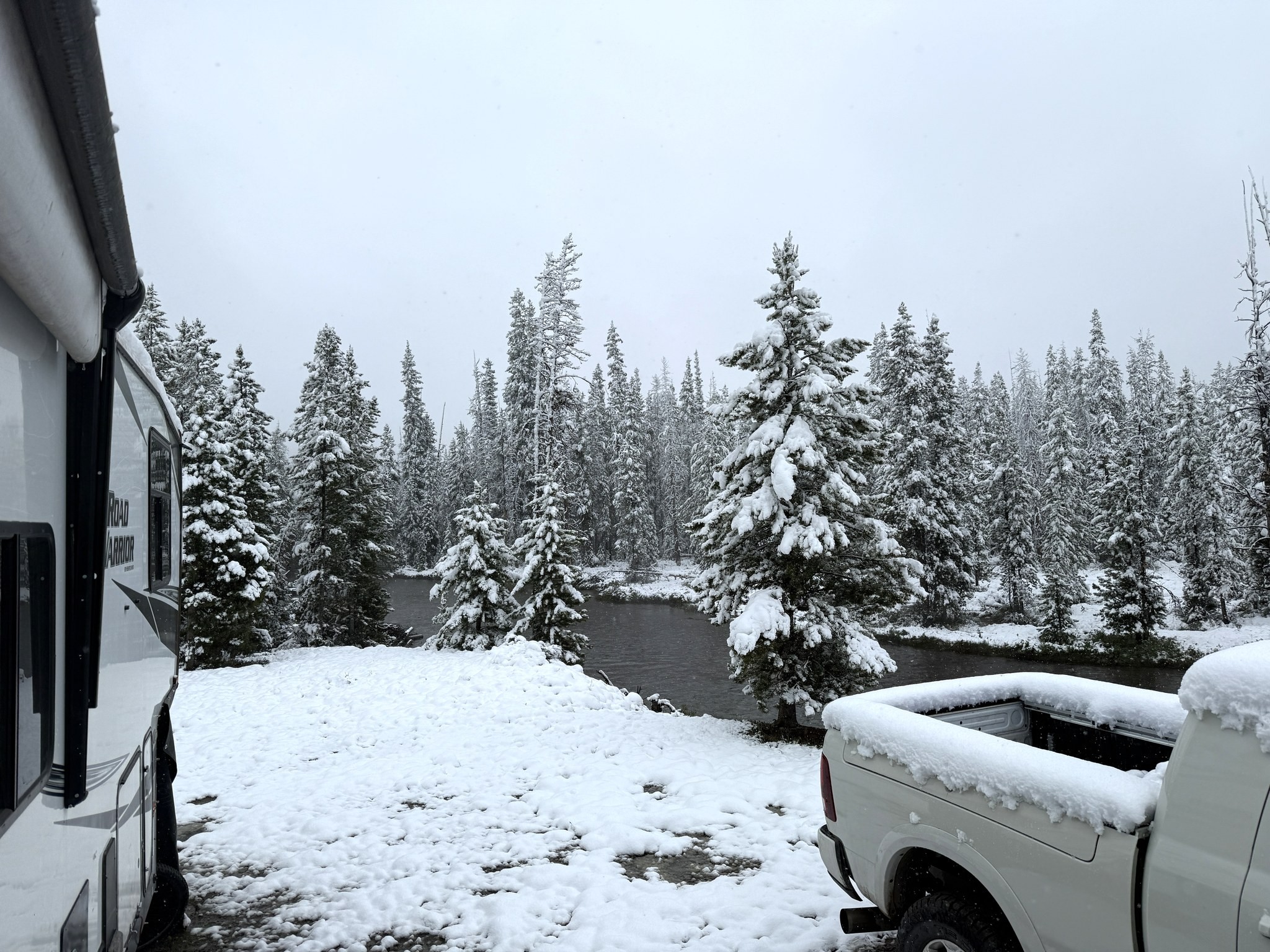 Snow-covered truck and RV the morning after an overnight snowfall in Stanley, Idaho