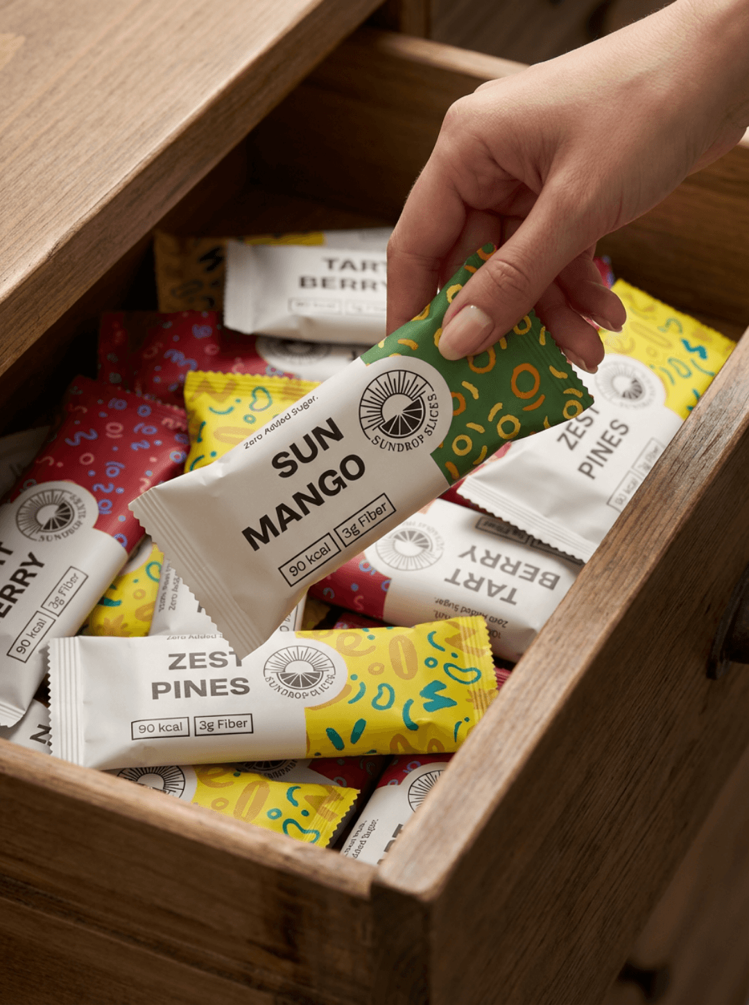 Person pulling papers out of a drawer with writing on them.