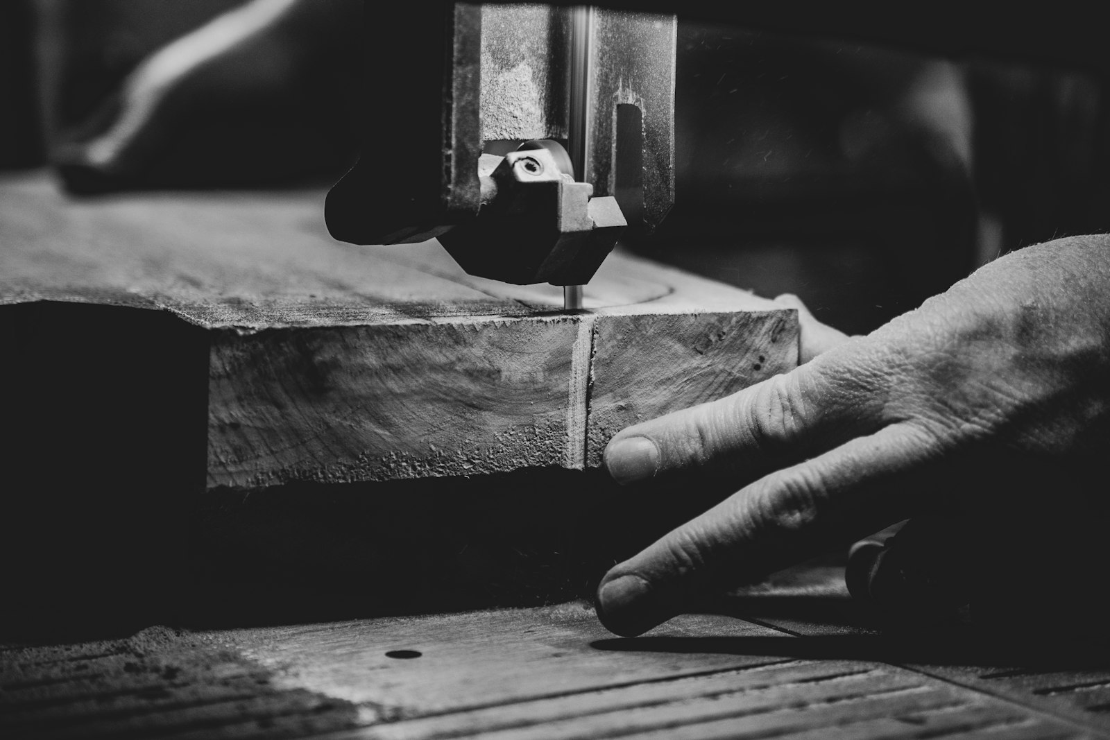 A craftsperson carefully cutting a wooden slab