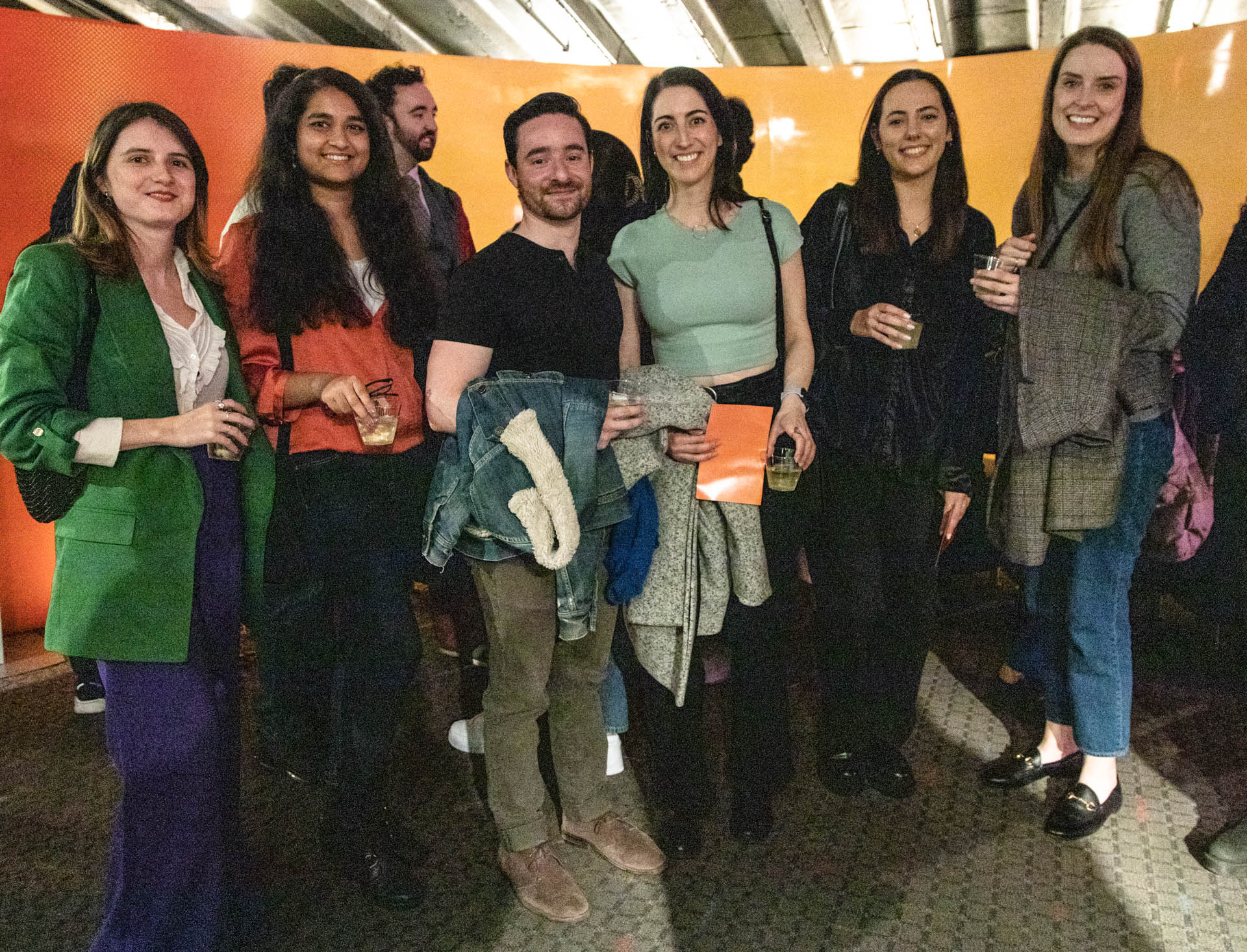 a group of students smiling for the camera in the SVA Theatre lobby after the Venture Forum