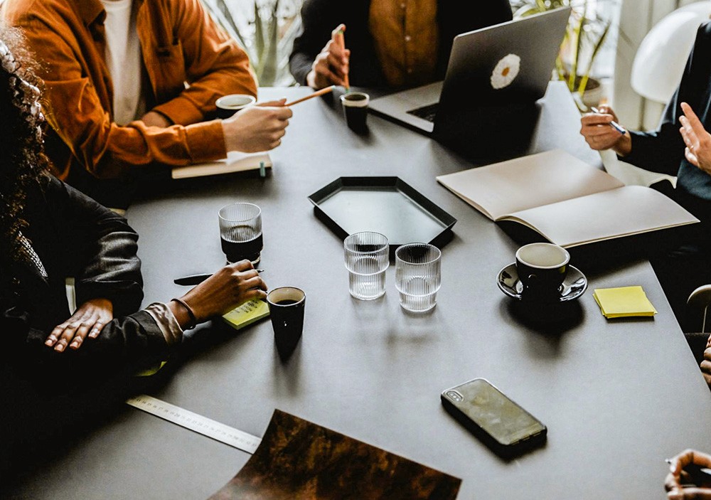 Meeting room desk with notes and drinks