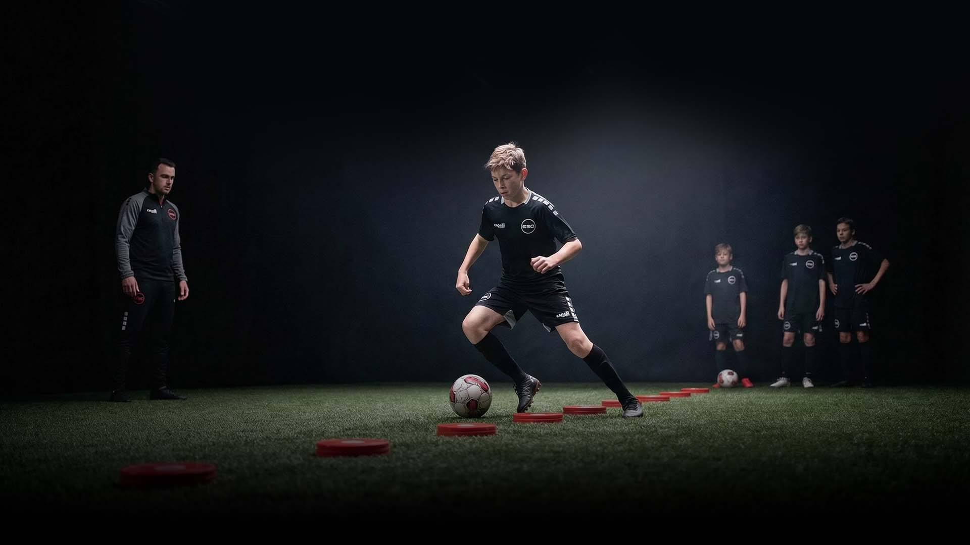 group of children playing soccer on green grass field during daytime