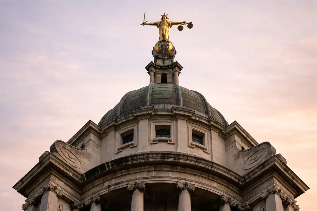 Lady Justice statue atop a domed building.
