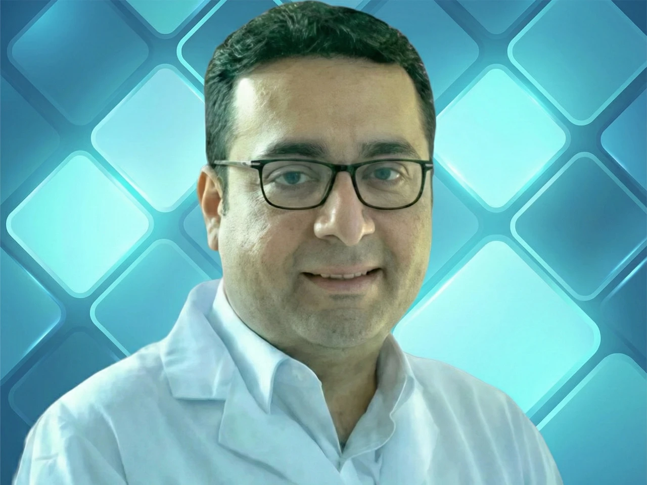 Dr. Tushar Aditya Narain, a senior robotic uro-oncologist, in a professional portrait against a blue background.