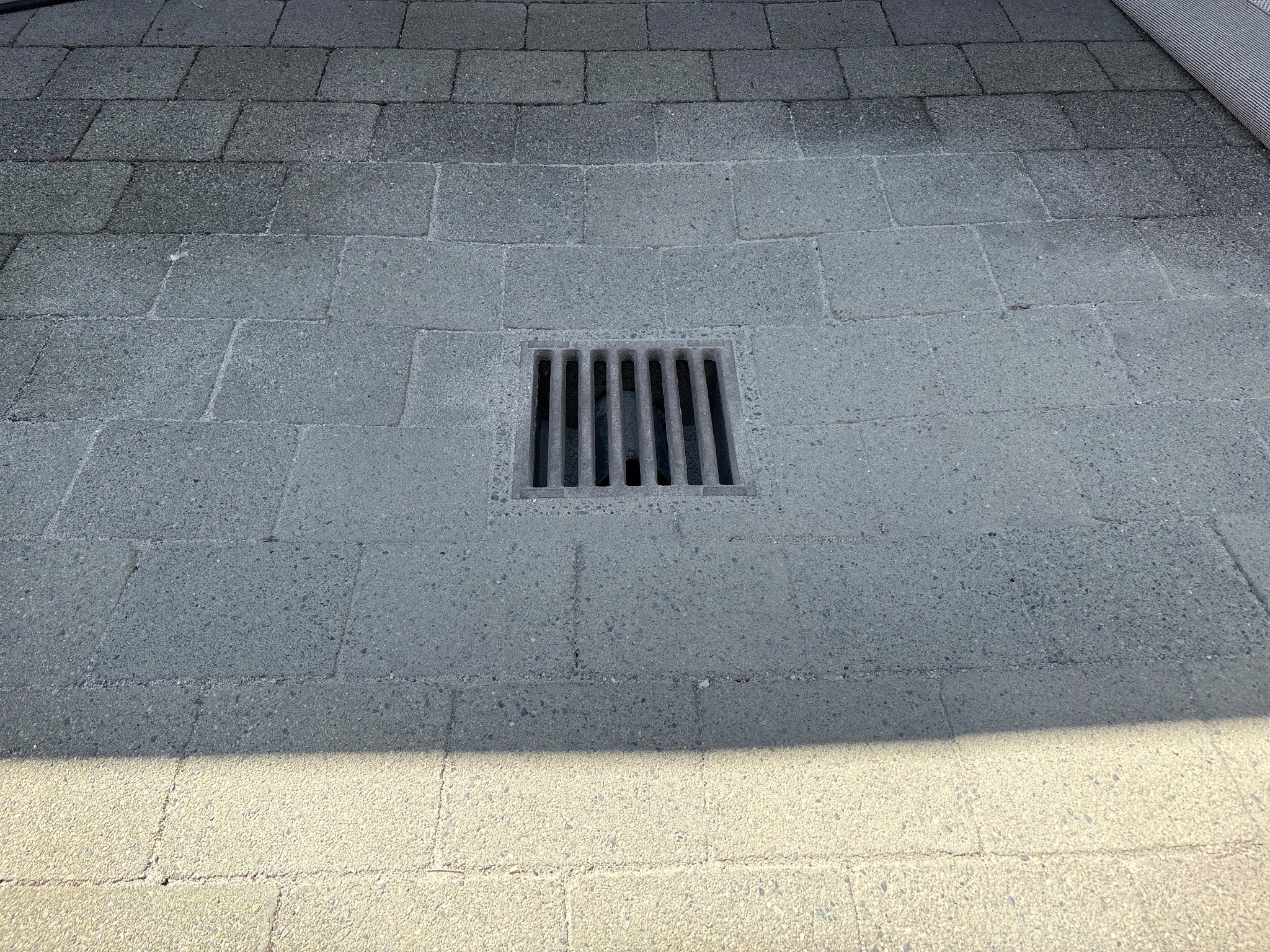 Completed patio paver and drainage repair with the surrounding surface restored.
