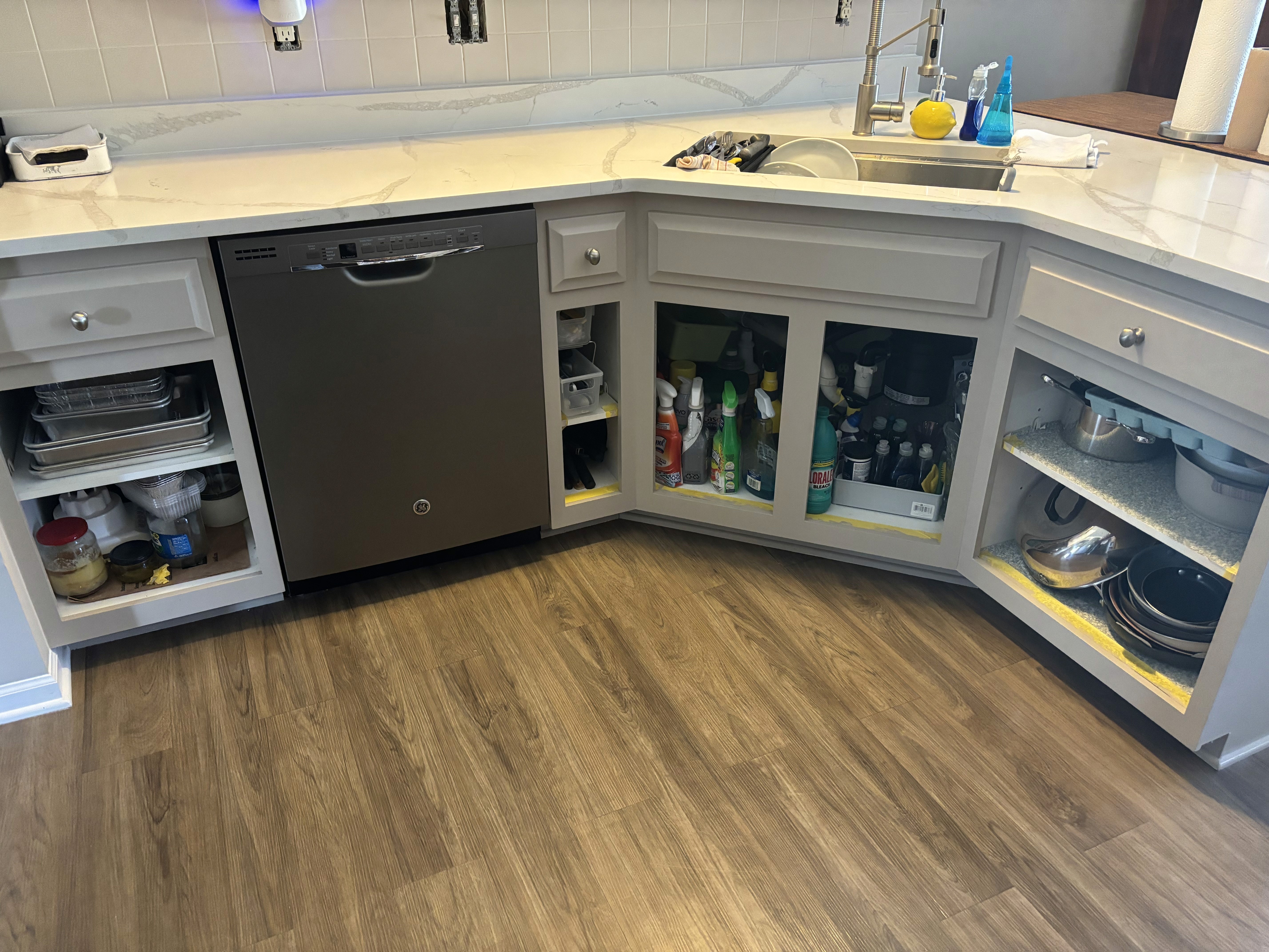 Clean completed kitchen with painted cabinetry and island