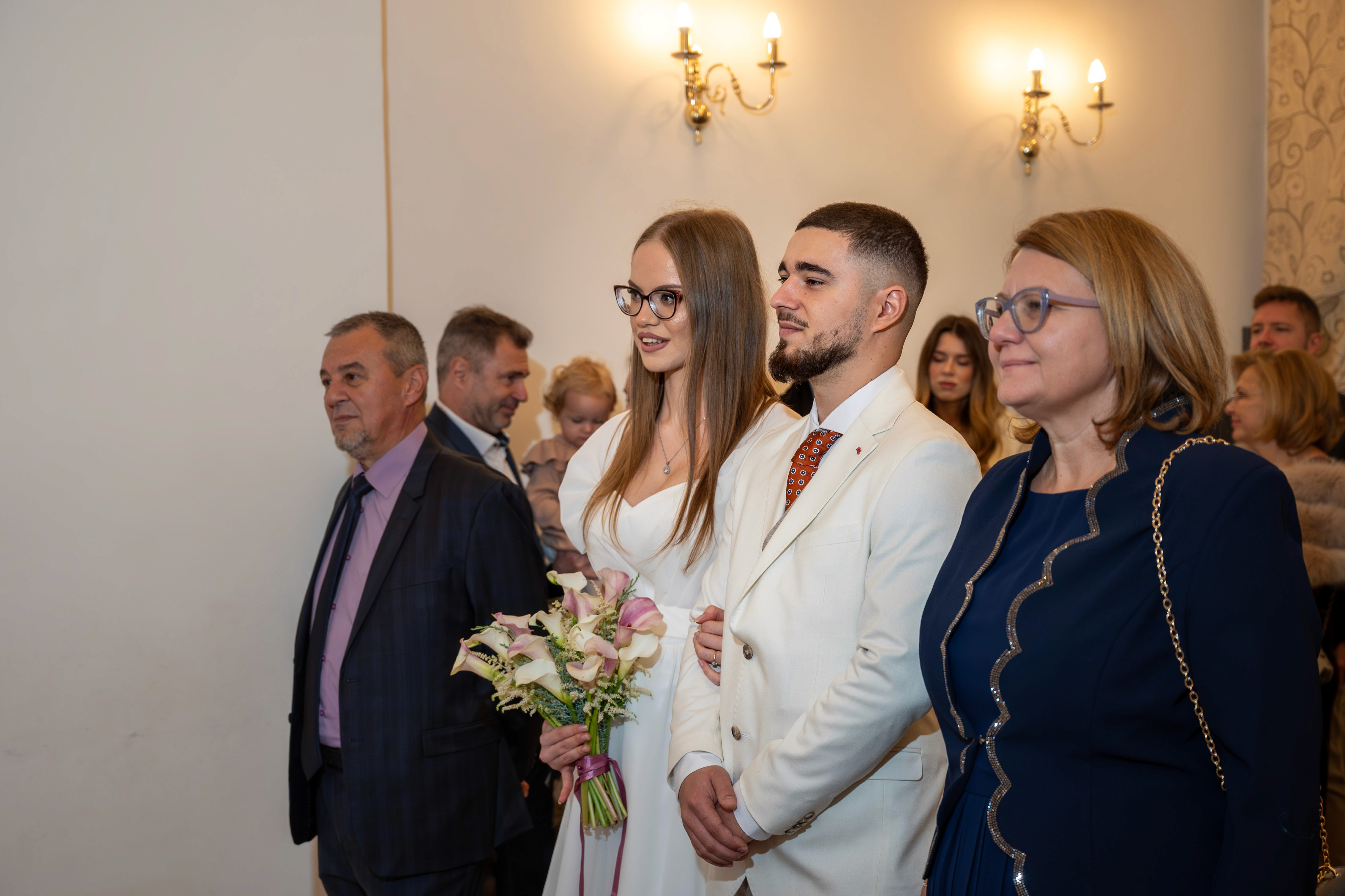 Moment oficial în sala de stare civilă, cu soț și soție în fața ofițerului.