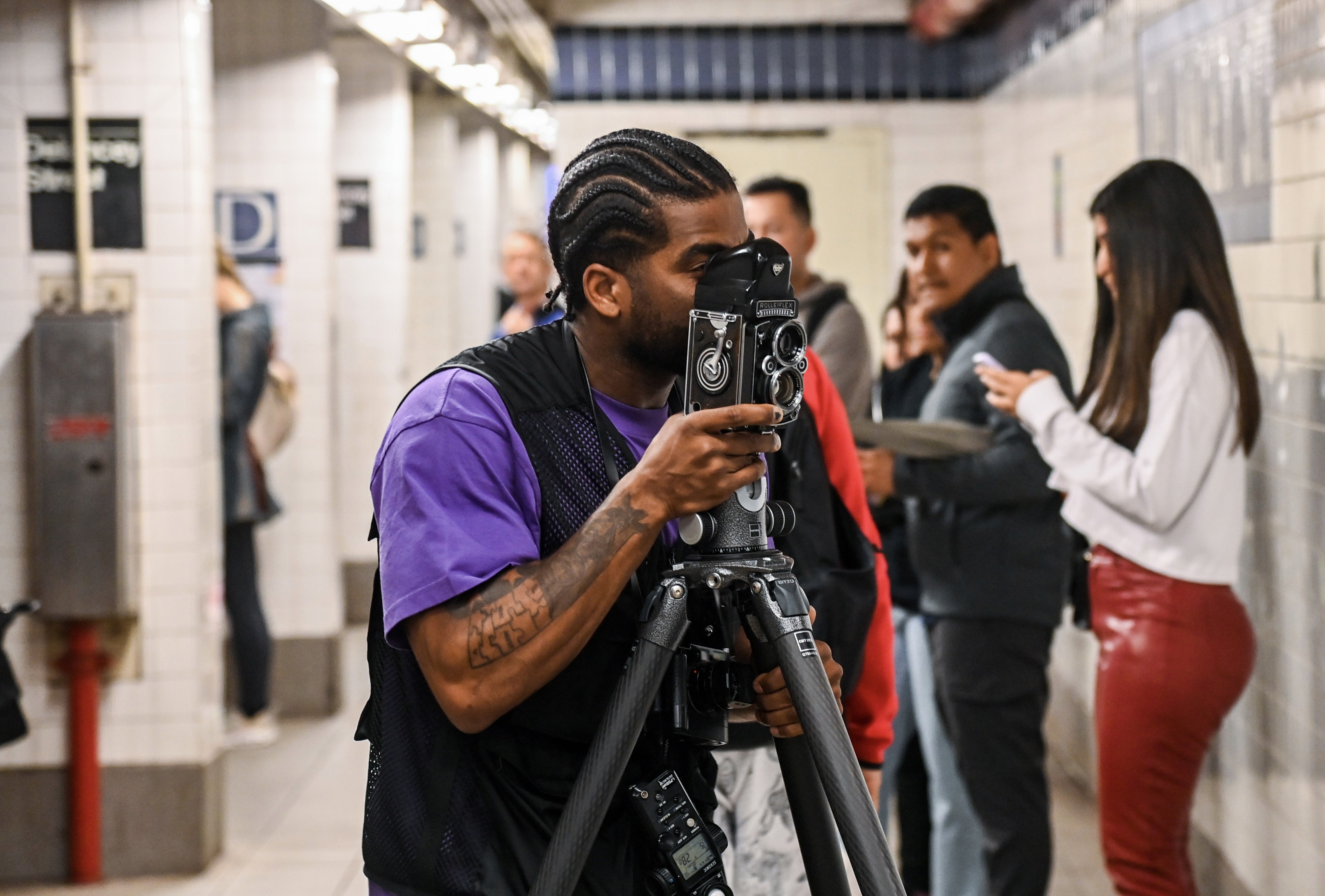Brooklyn-based photographer Andre D. Wagner taking photos on a subway platform