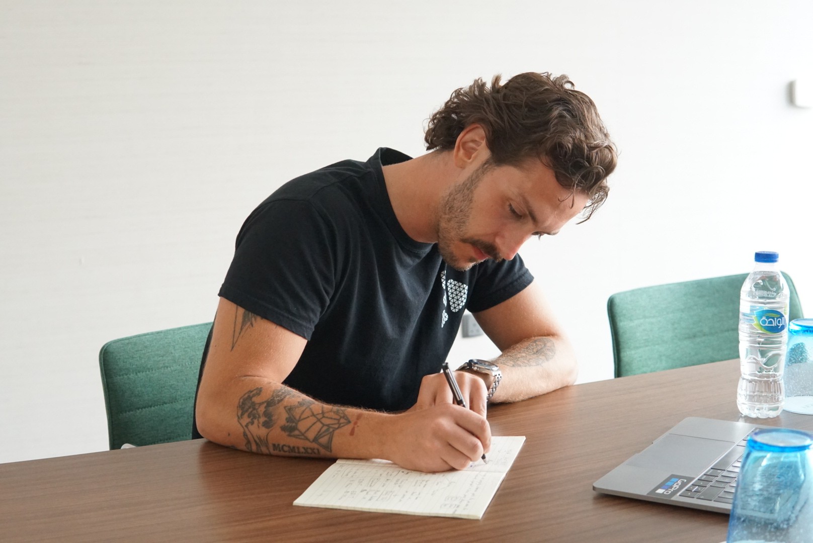 Filip Mircheski writing in a notebook