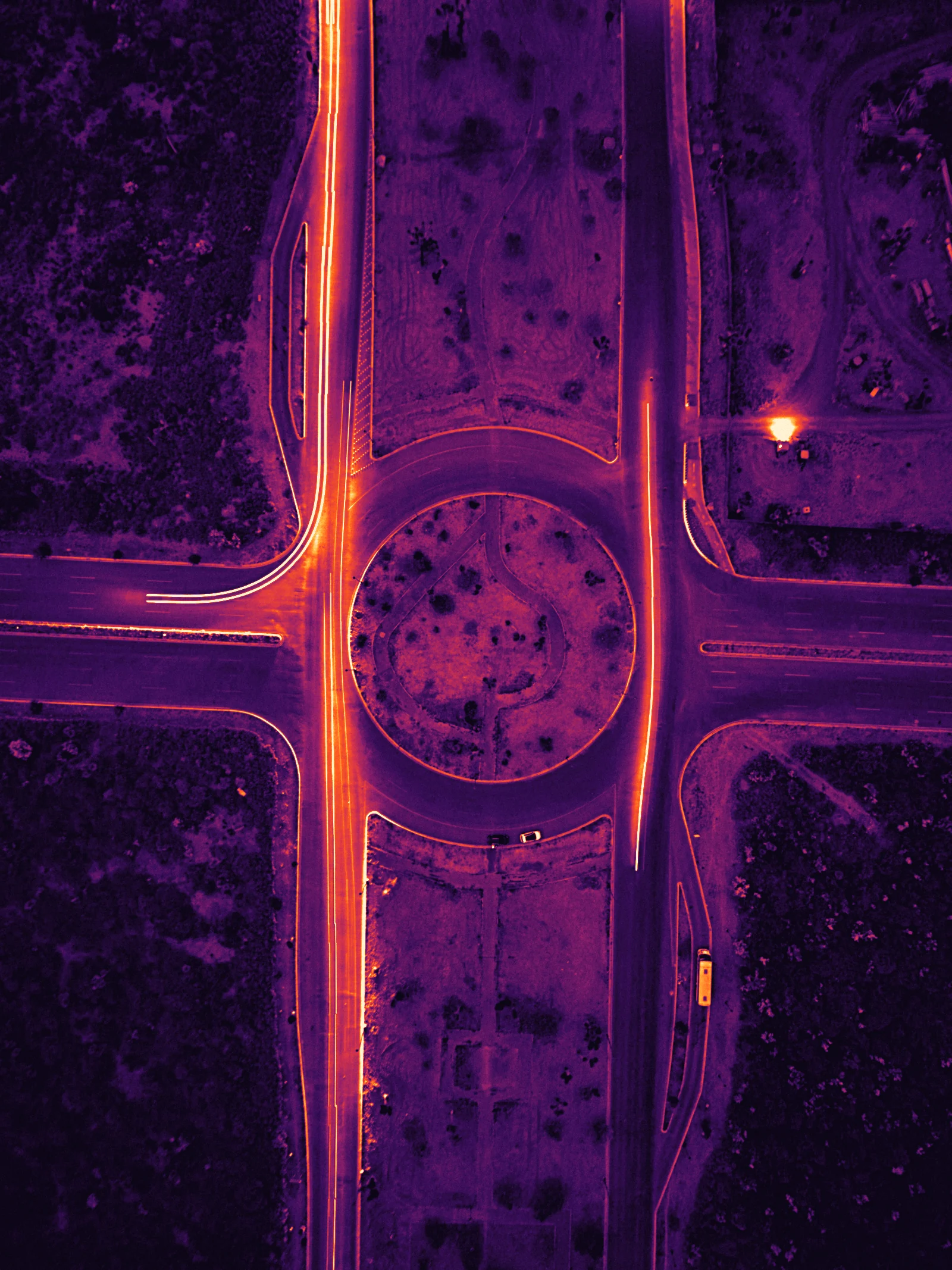 Light trails on a roundabout at night, seen from above