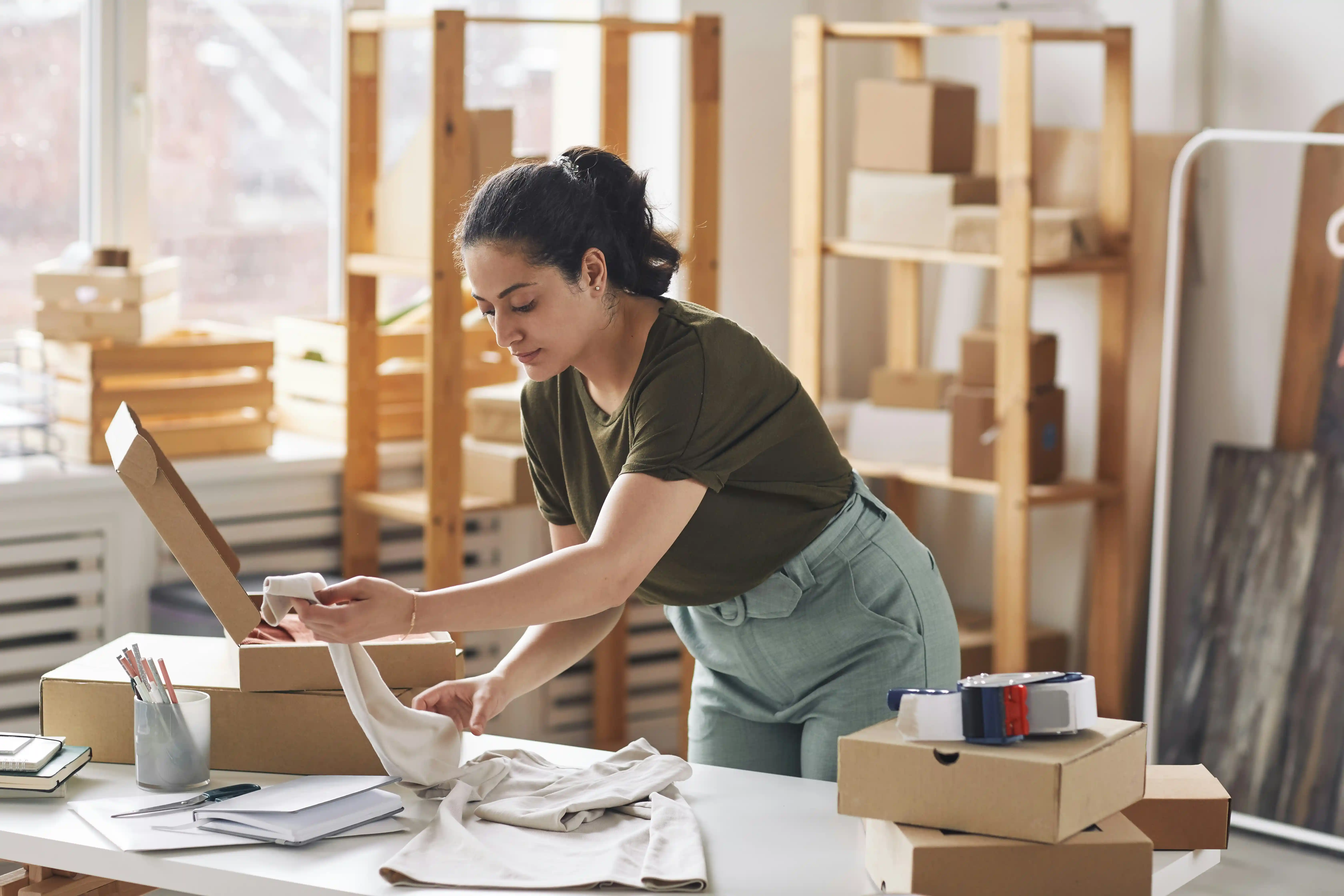 woman packing packages for her webstore