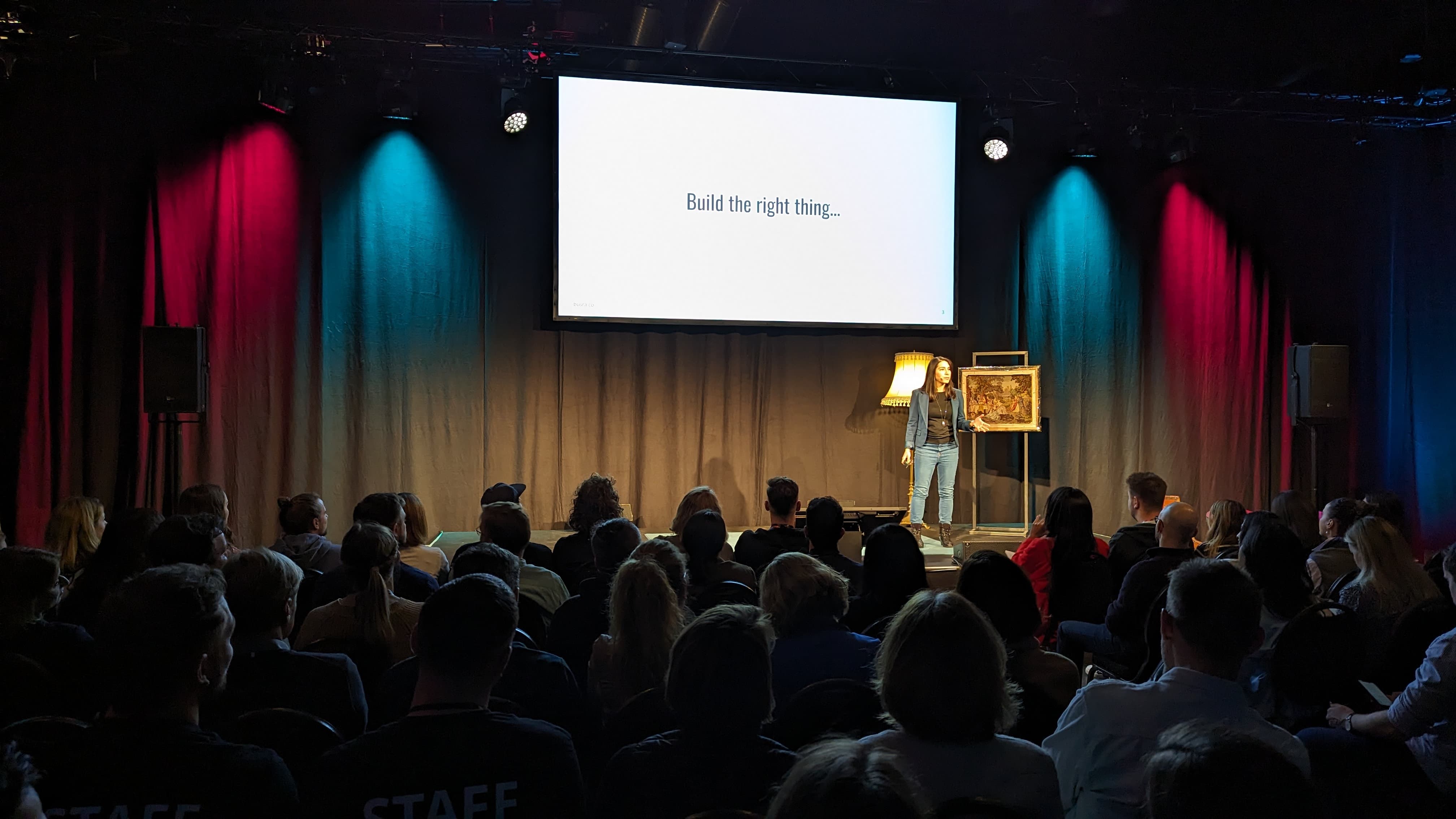 woman holding a phone and man looking at the phone. both are smiling