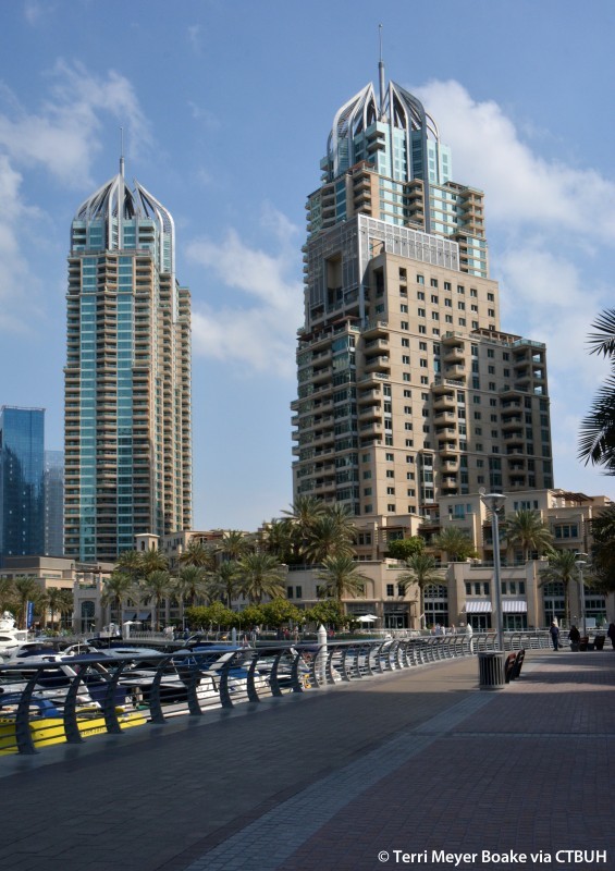 Scenic promenade view of Mesk Tower and surrounding luxury properties in the marina.