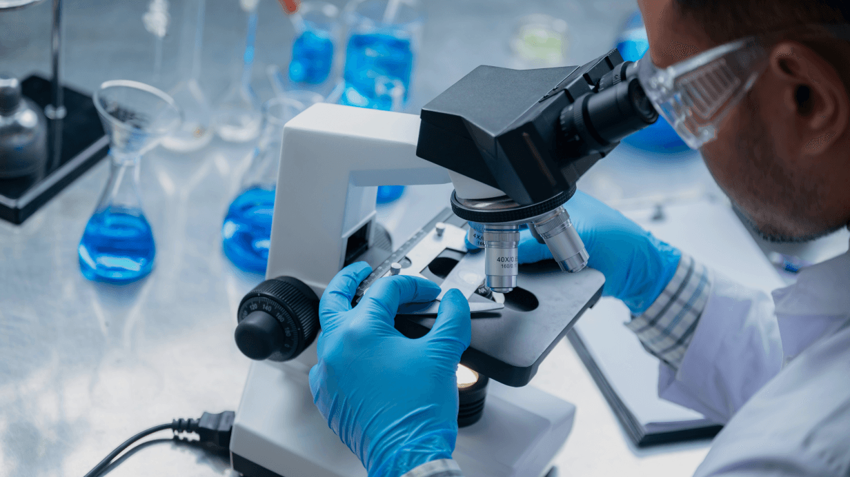 A scientist looking through a microscope