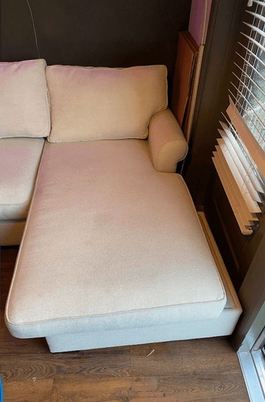 man in gray hoodie and blue denim jeans standing on brown wooden parquet flooring