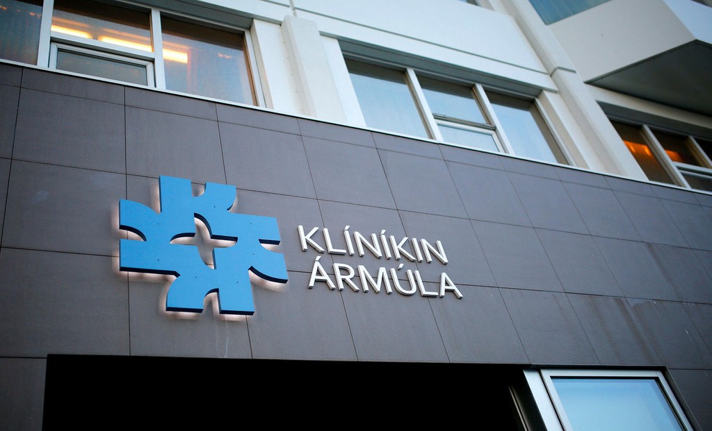 An empty road with a hospital in the background.