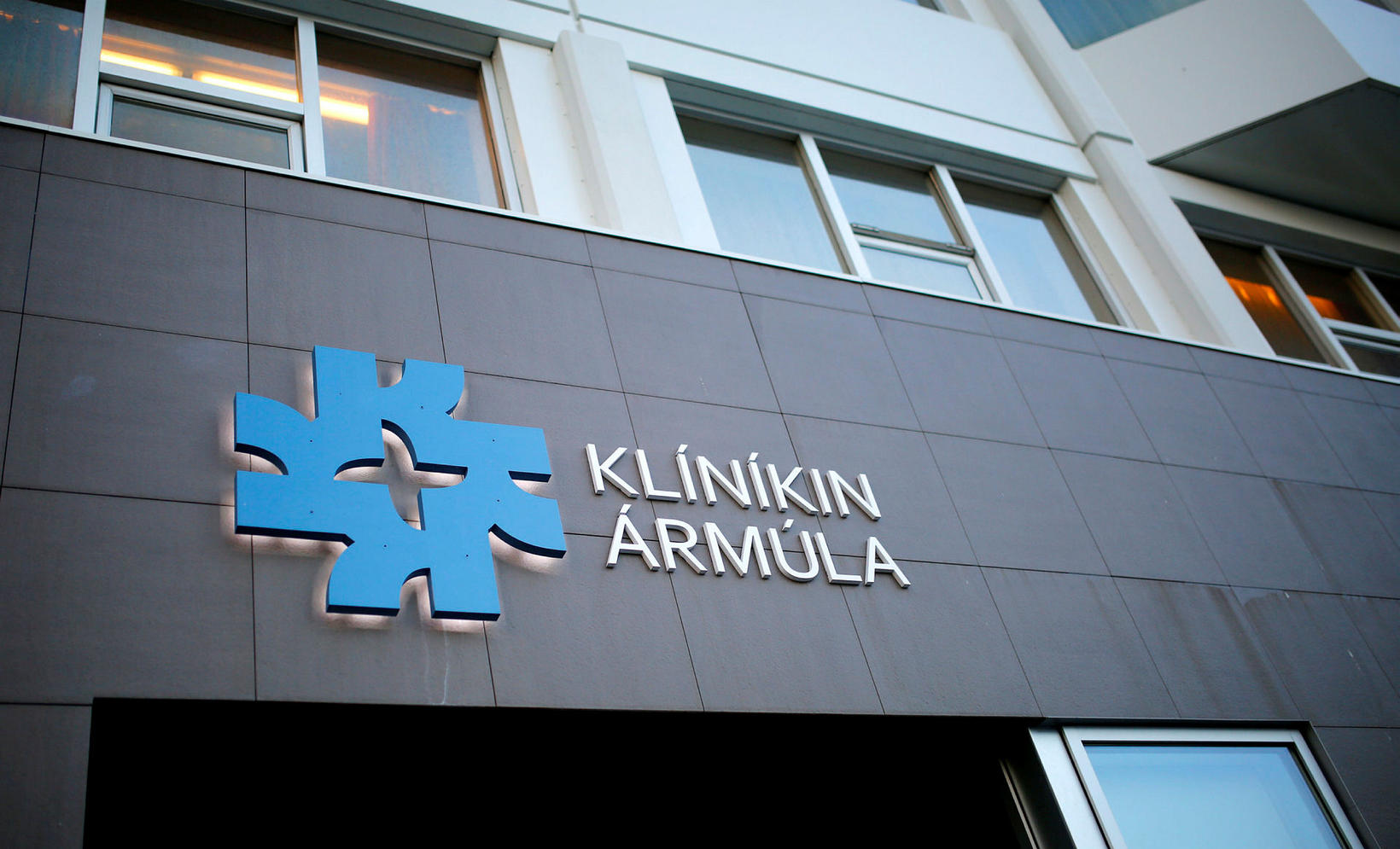 An empty road with a hospital in the background.