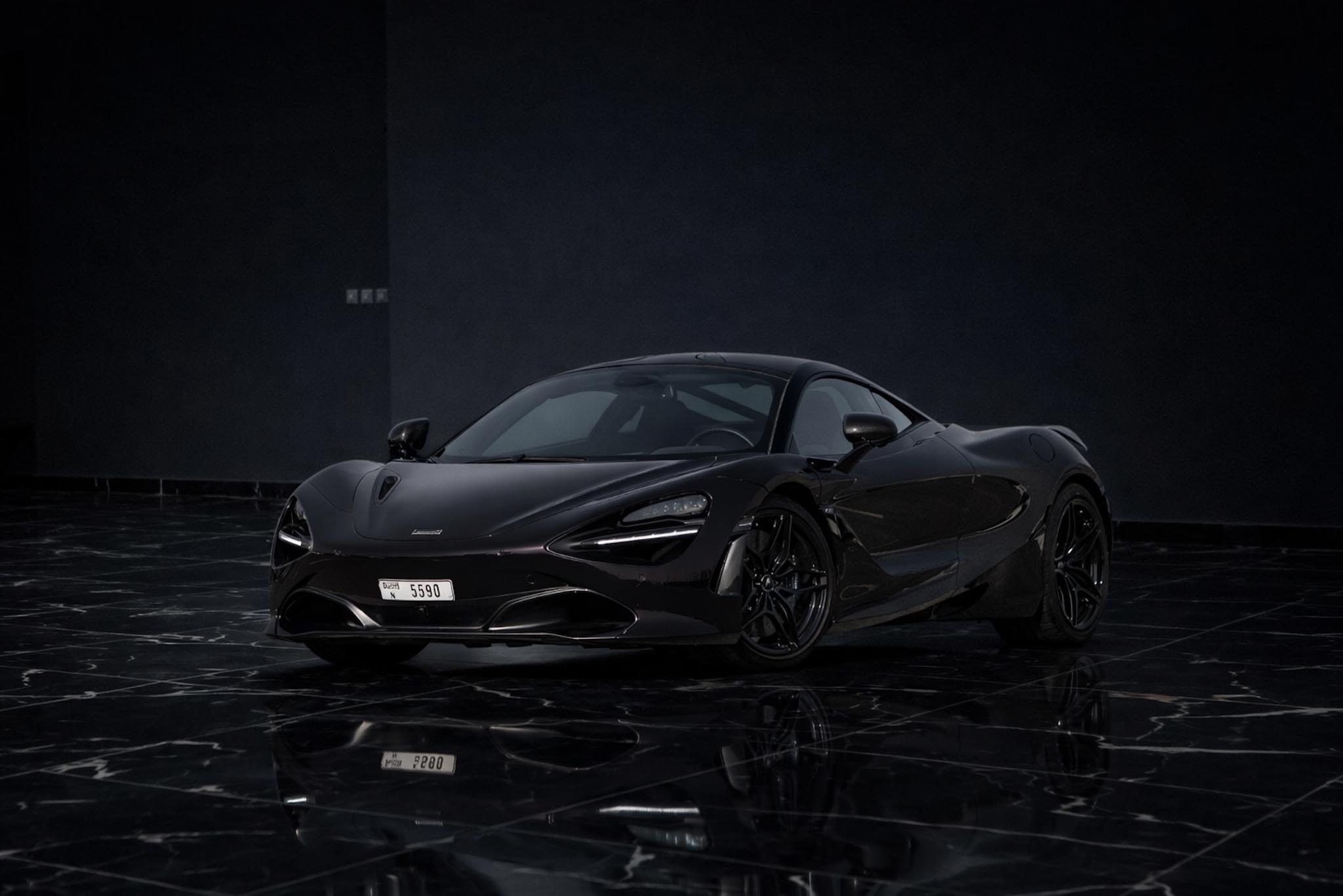 McLaren 720S Coupe 2021 black front side exterior doors closed luxury supercar rental in Dubai