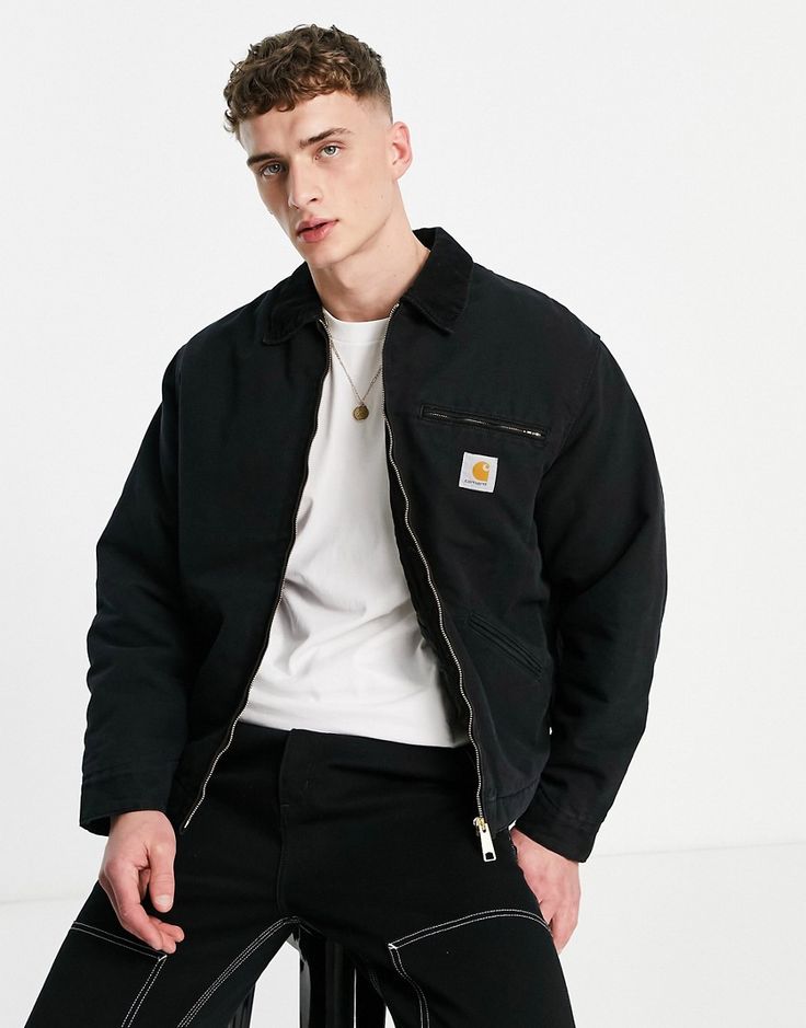 a male model wearing the carharrt branded jacket