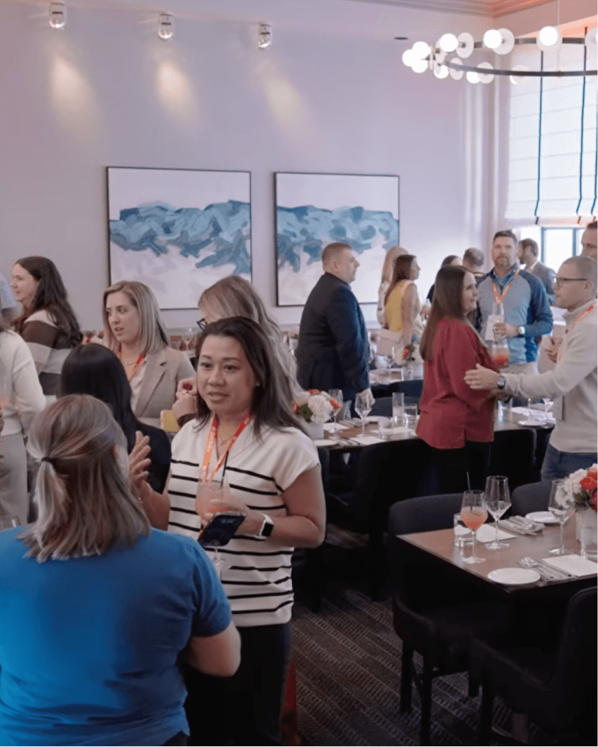 A group of people conversing at a SmithRx Hosted Event