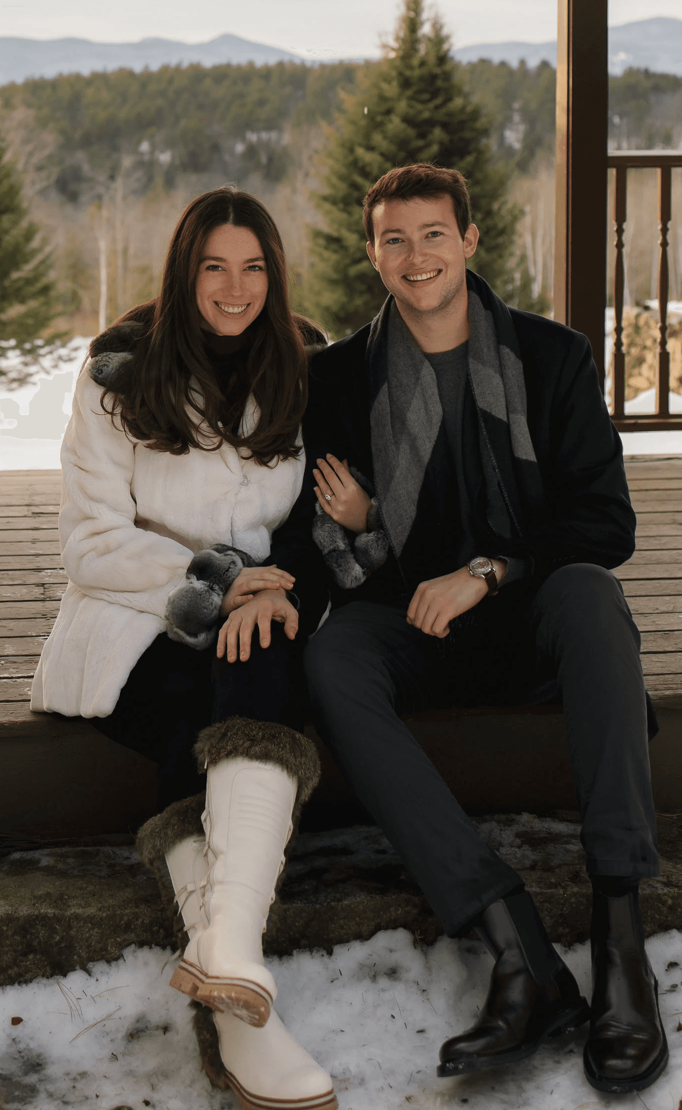 A couple stands outdoors at sunset.