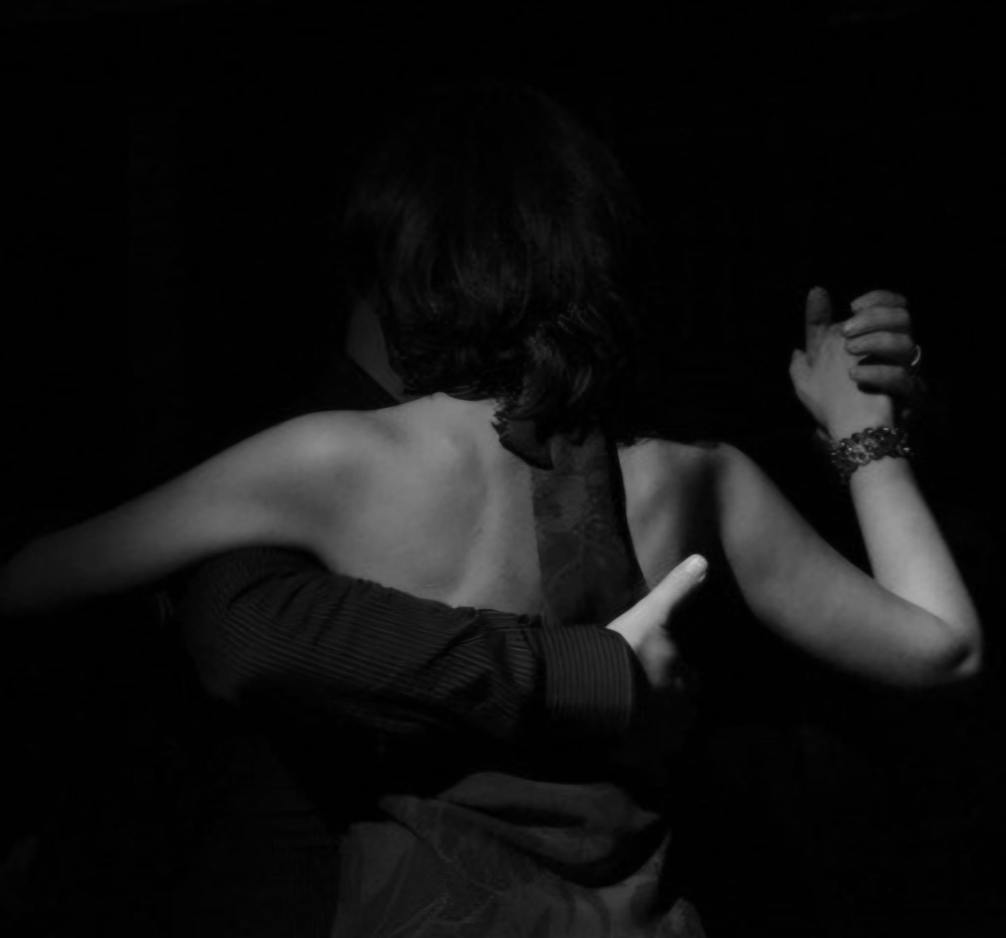 a man and a woman dancing in the dark