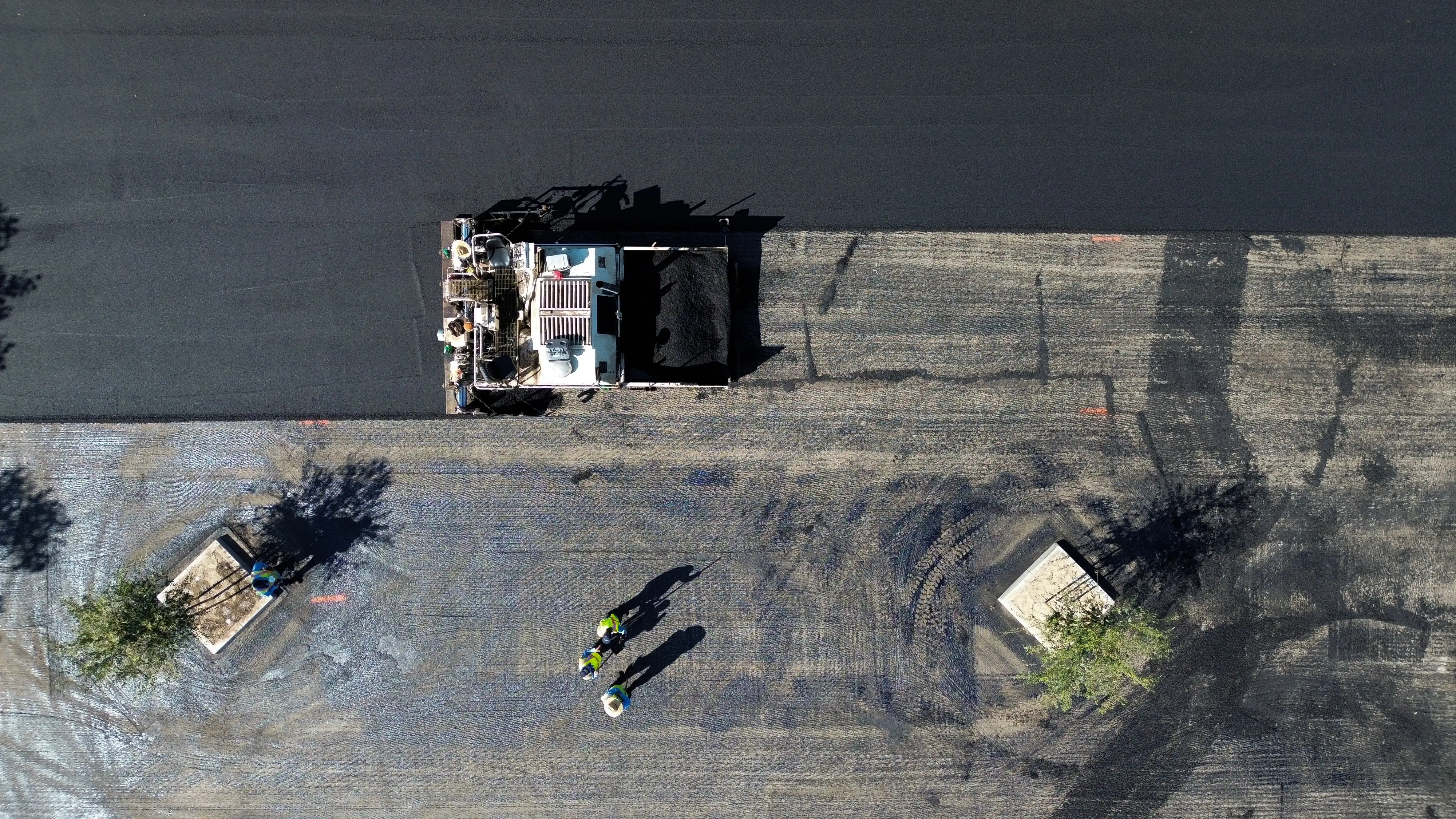 Aerial top-down photo of parking lot being paved