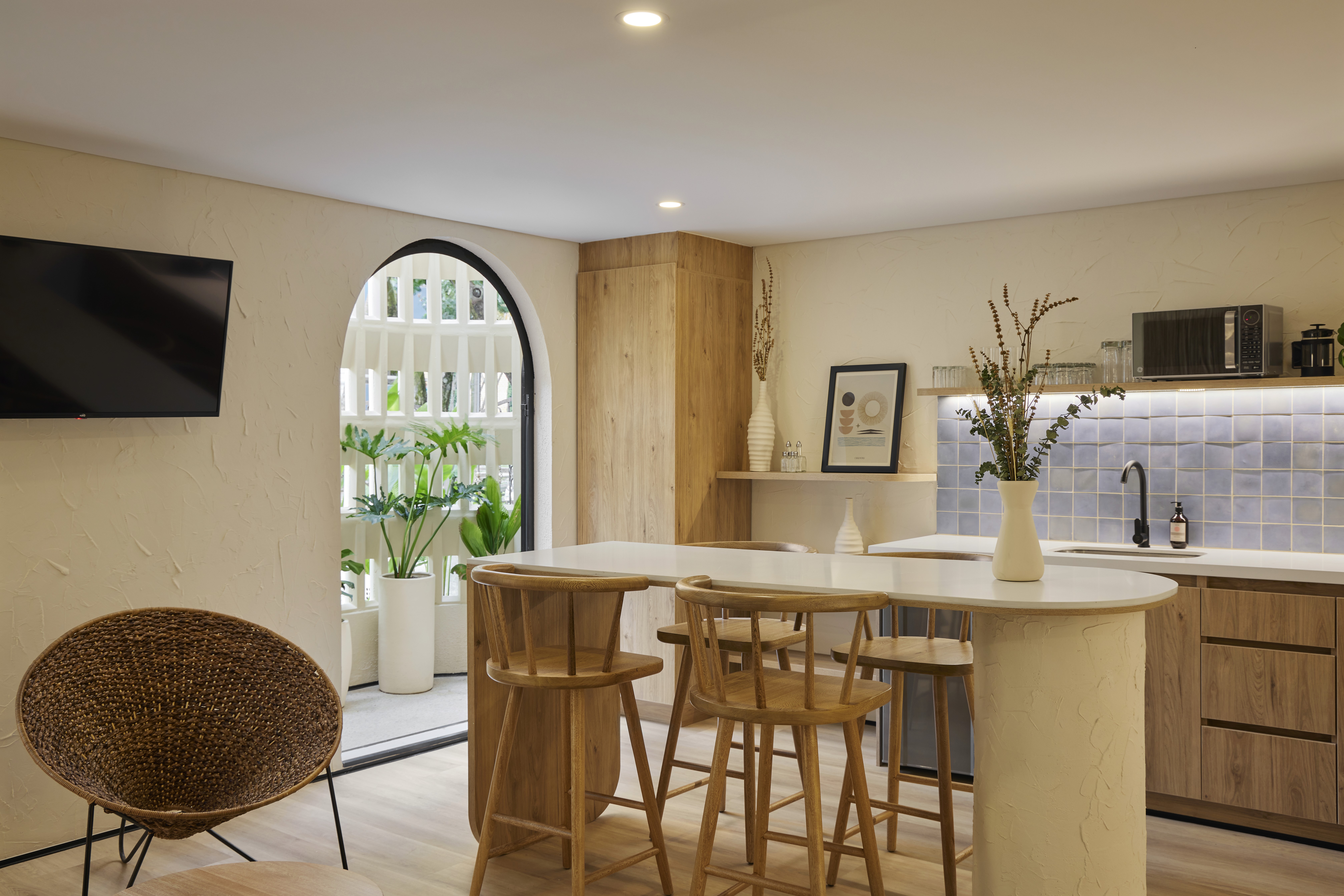 Double-height interior with flowing sculptural forms and warm raking light