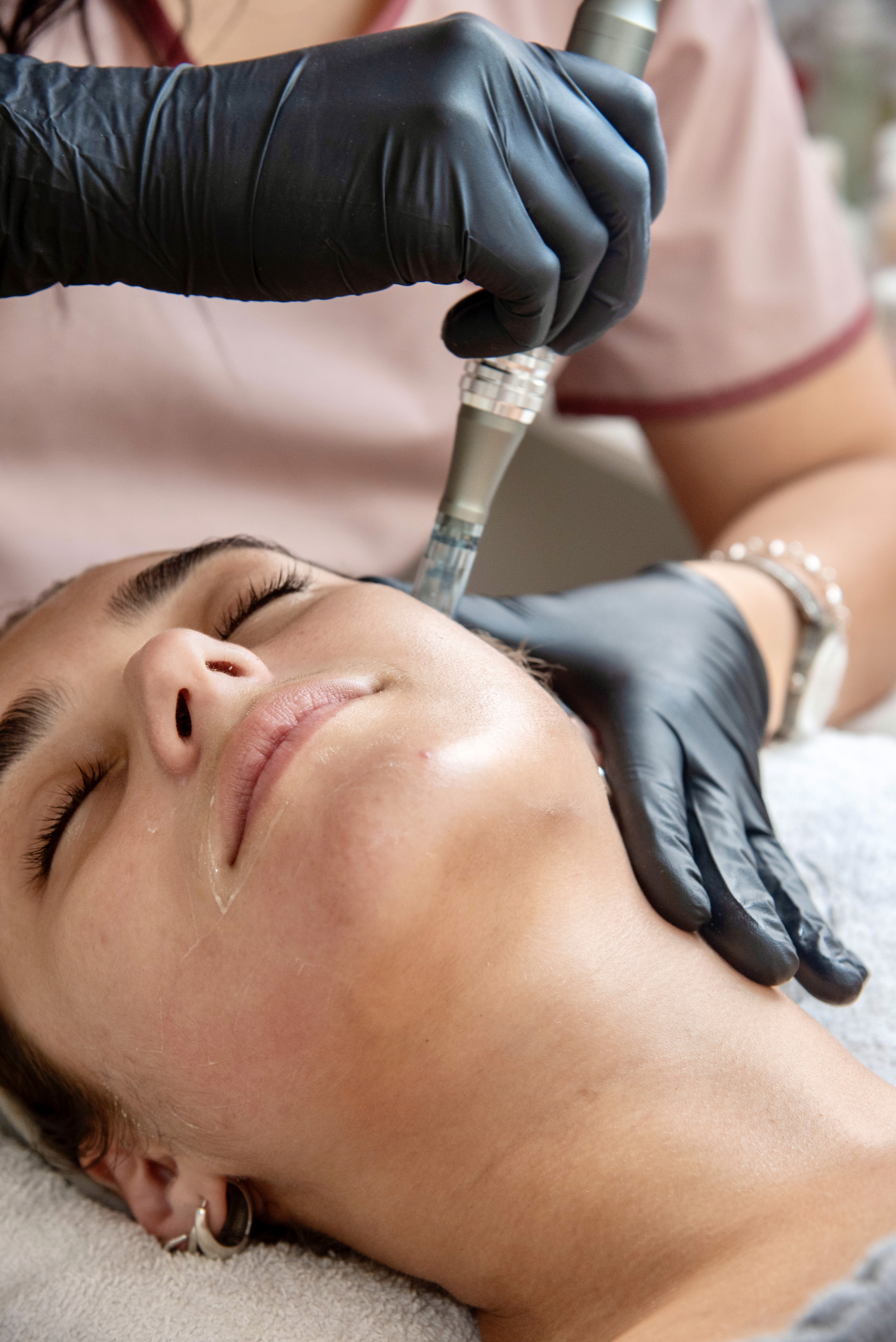 A serene spa setting with two lounge chairs beside a warm, reflective pool and soft, natural lighting.